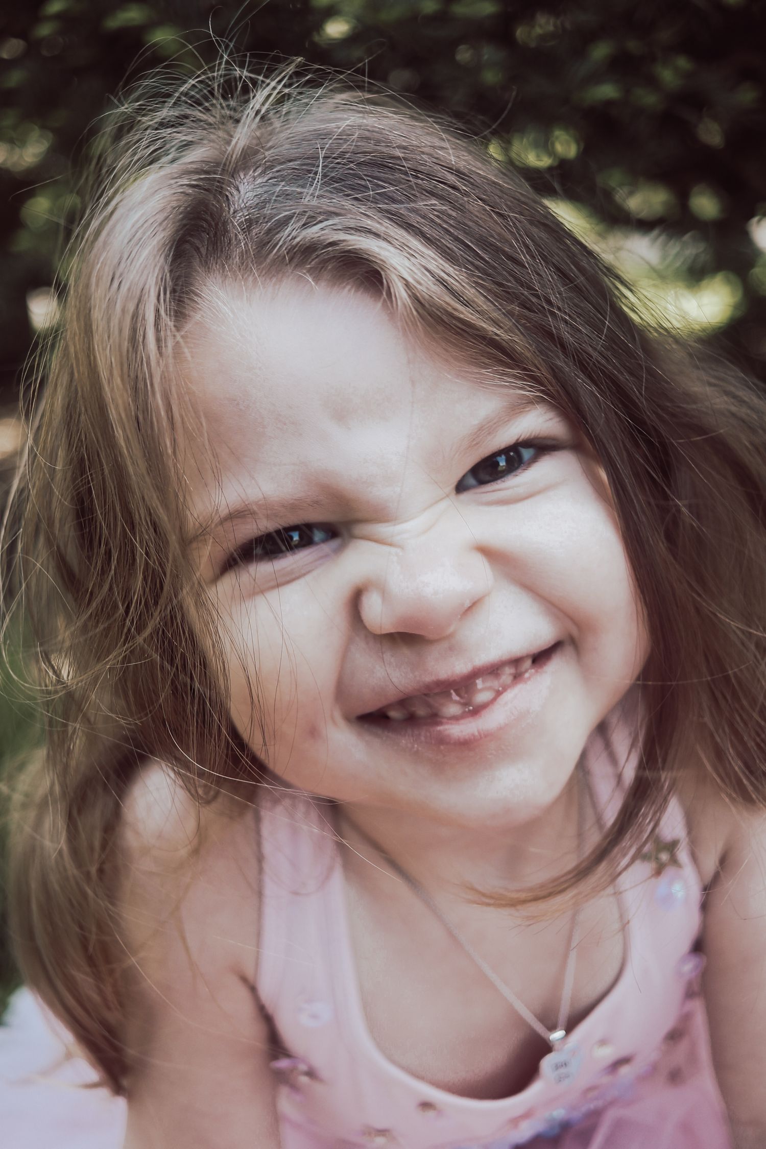 A series of close-up photos showing joyful expressions and playful poses with windswept hair.
