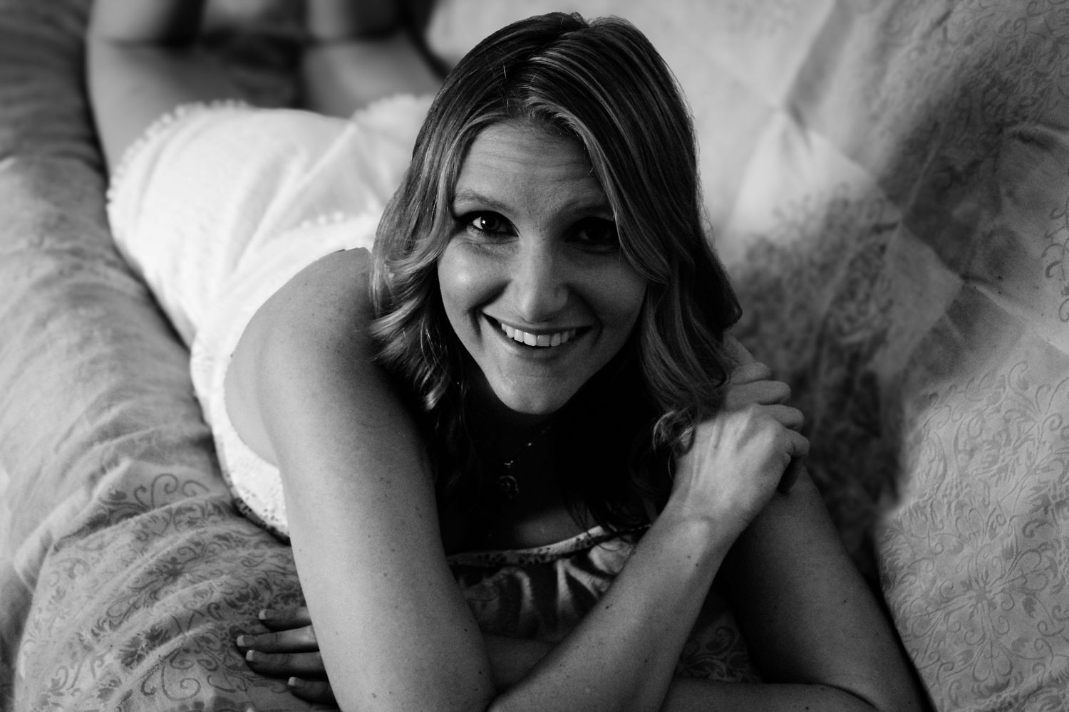 A series of black and white romantic portraits showing a couple embracing and smiling together.