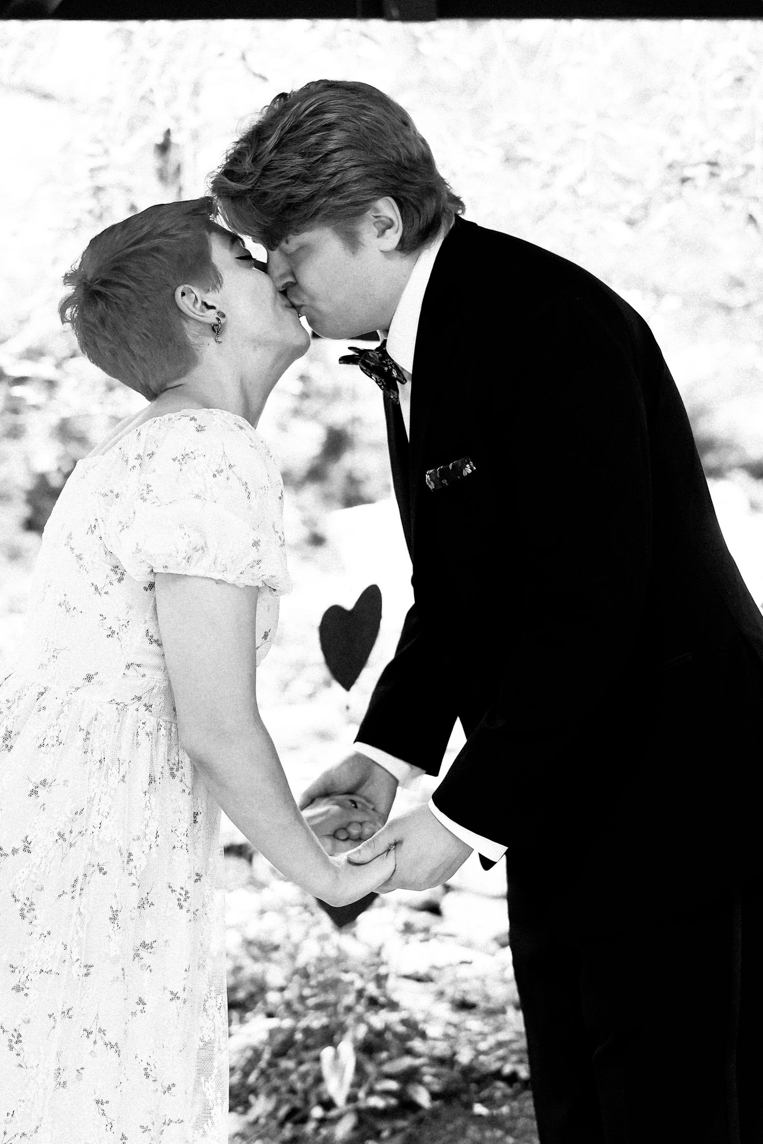 A romantic black and white wedding photo montage shows intimate moments between couples in formal attire.