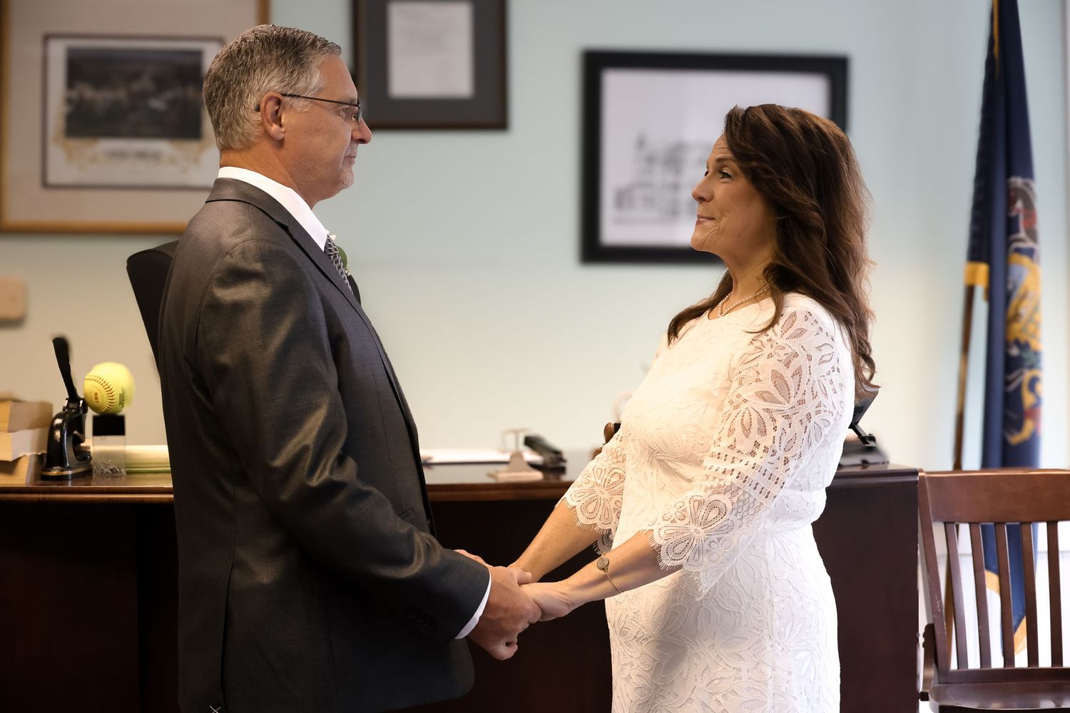 A couple exchanges vows during an intimate courthouse wedding ceremony.