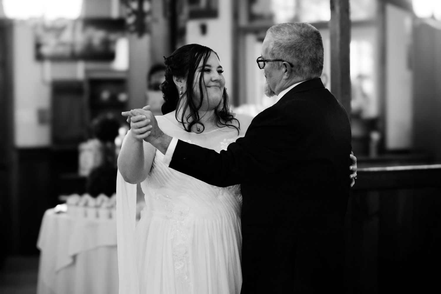 A black and white wedding photo series showing intimate moments between the couple during their special day.