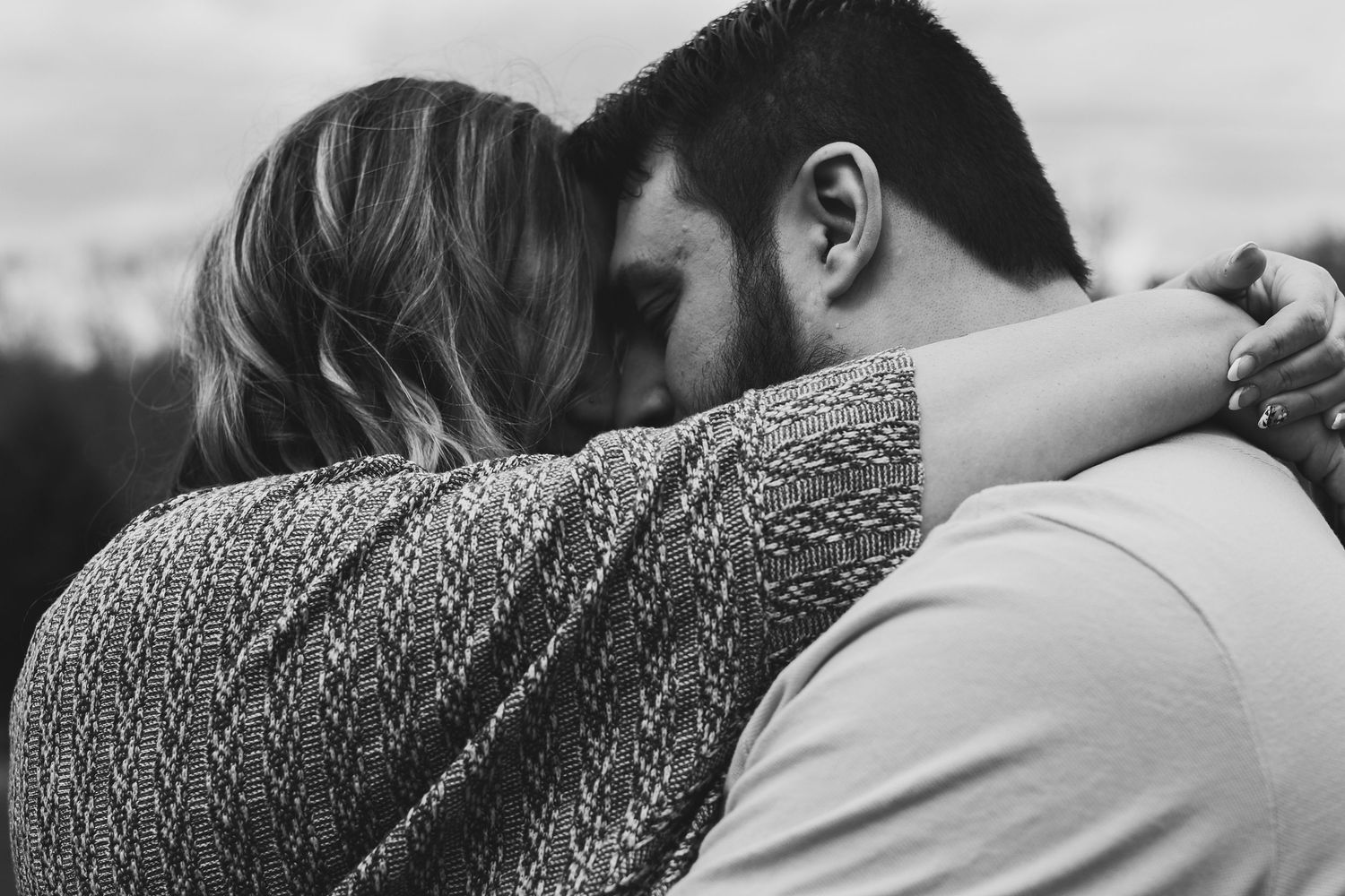 A series of black and white photos showing close-up embraces and intimate moments between two people.
