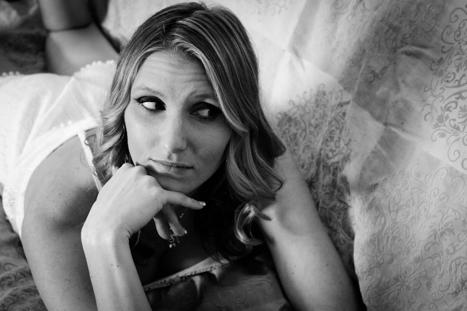 Black and white artistic portrait series showing different emotional expressions and poses against a light background.