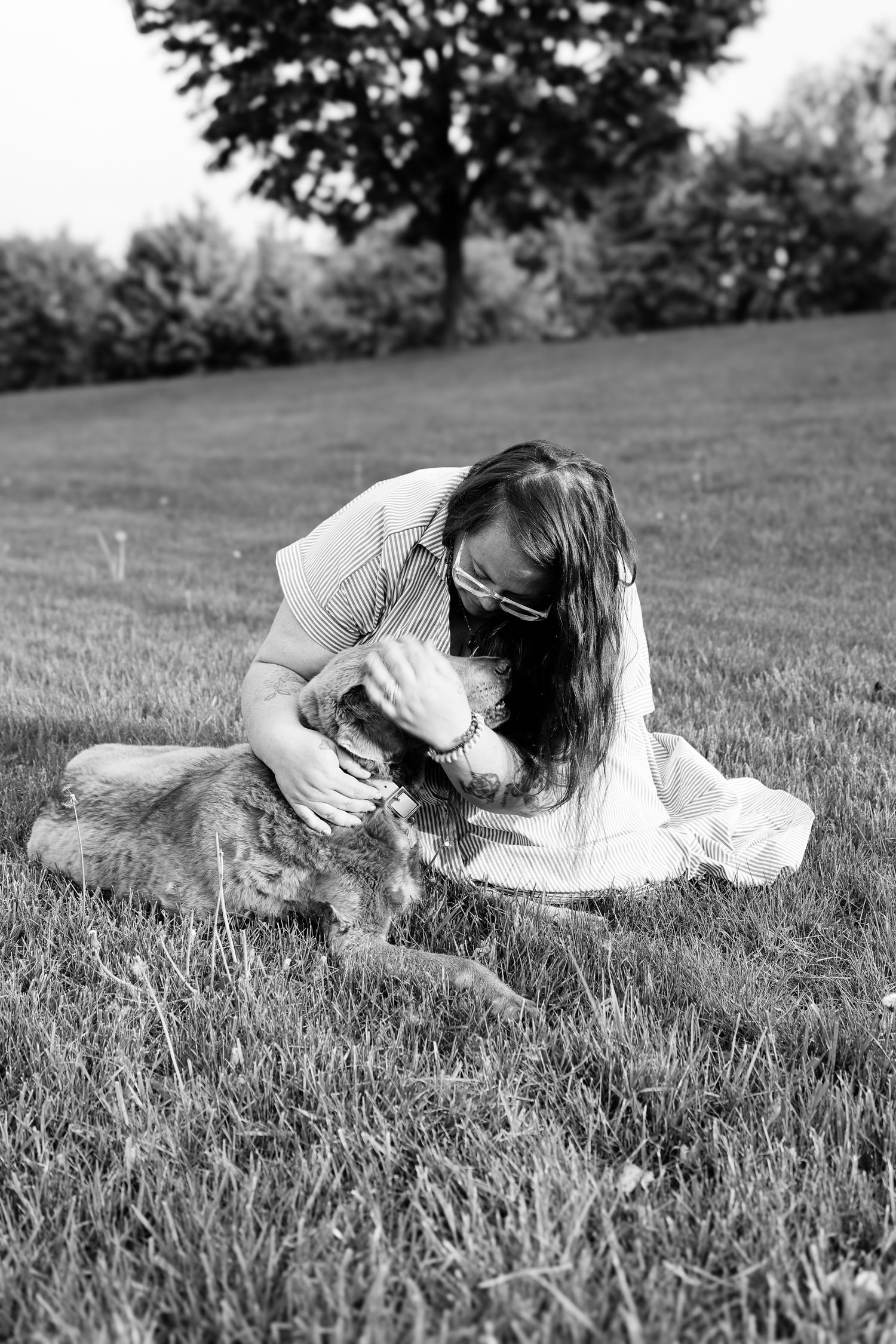 Black and white artistic photo series showing a person in white dress lying in grass with graceful movement poses.