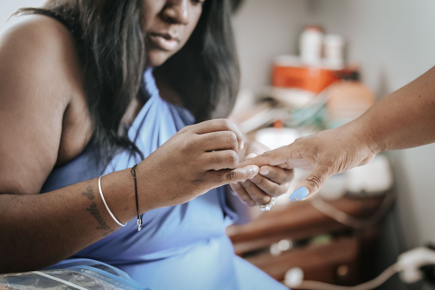 Medical professional administers a vaccine injection into patient's arm while wearing protective gloves.