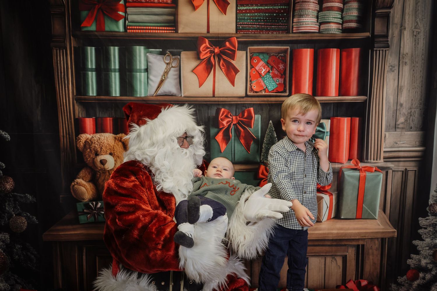 A festive holiday scene with red bows and decorations adorning wooden bookshelves in a cozy library setting.