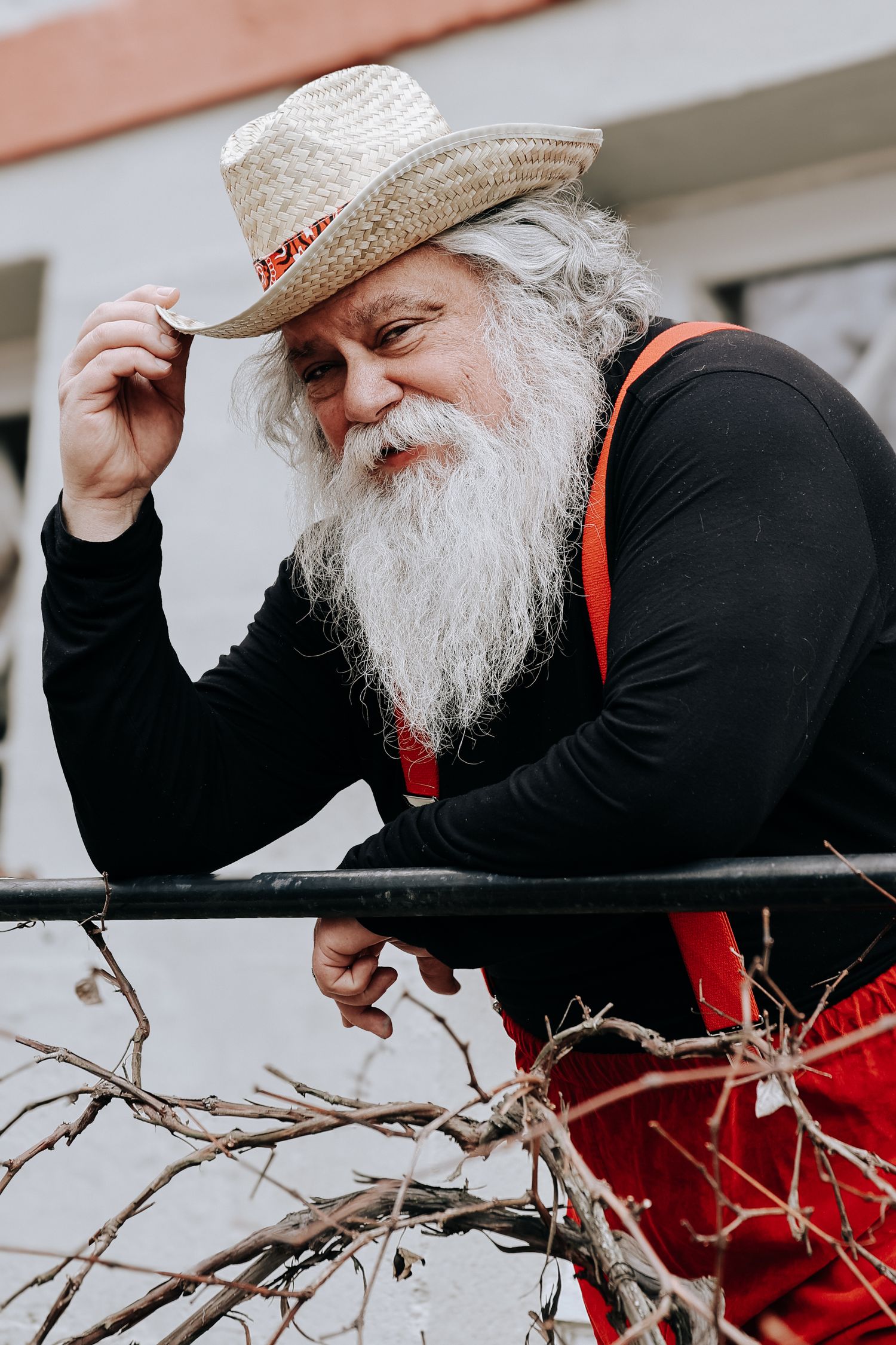 A person wearing a straw hat and white beard leans forward in a series of progressive action shots.