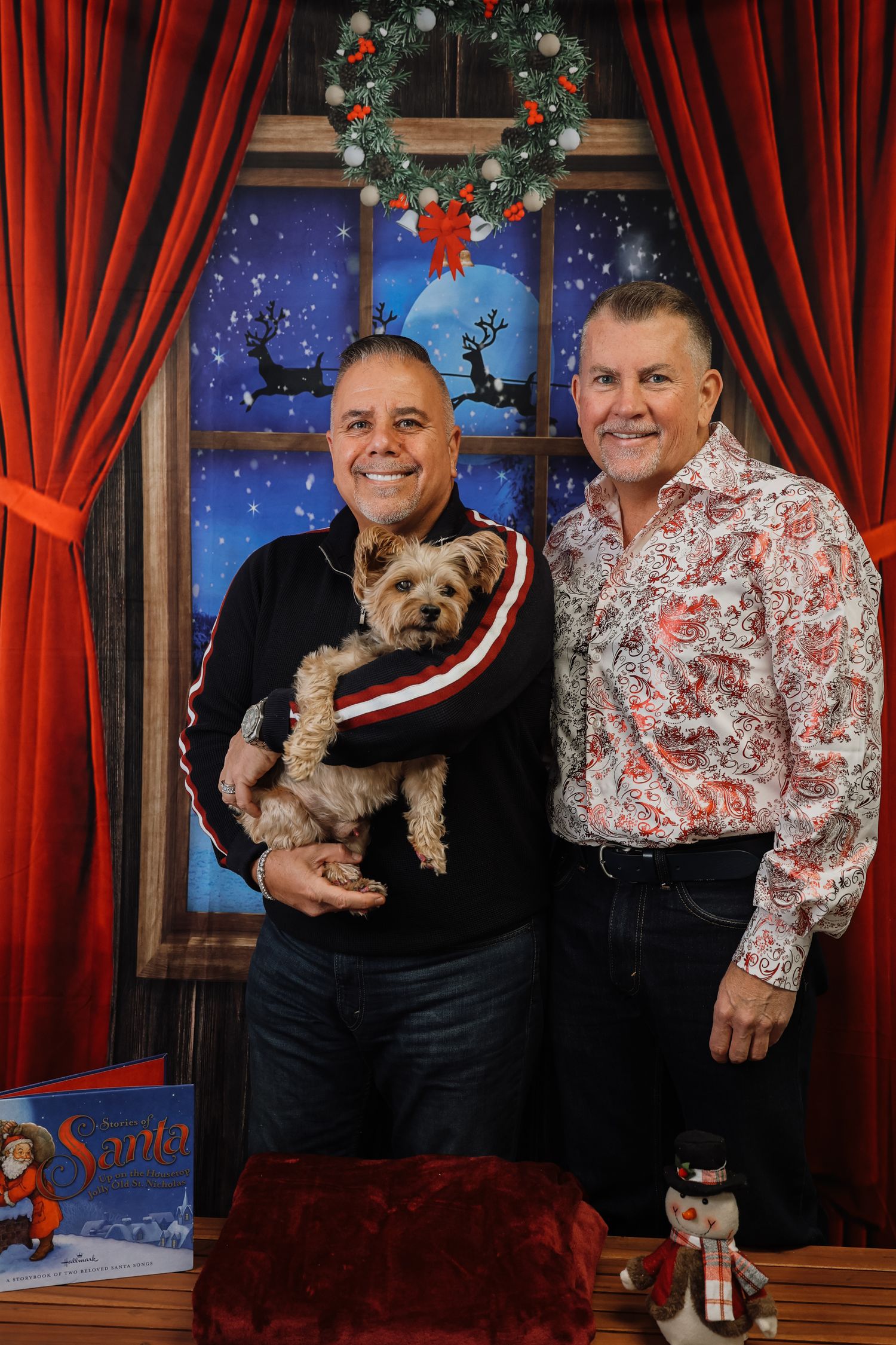 Four sequential holiday photos show a couple in matching red and white outfits posing with a small dog in a festive setting.