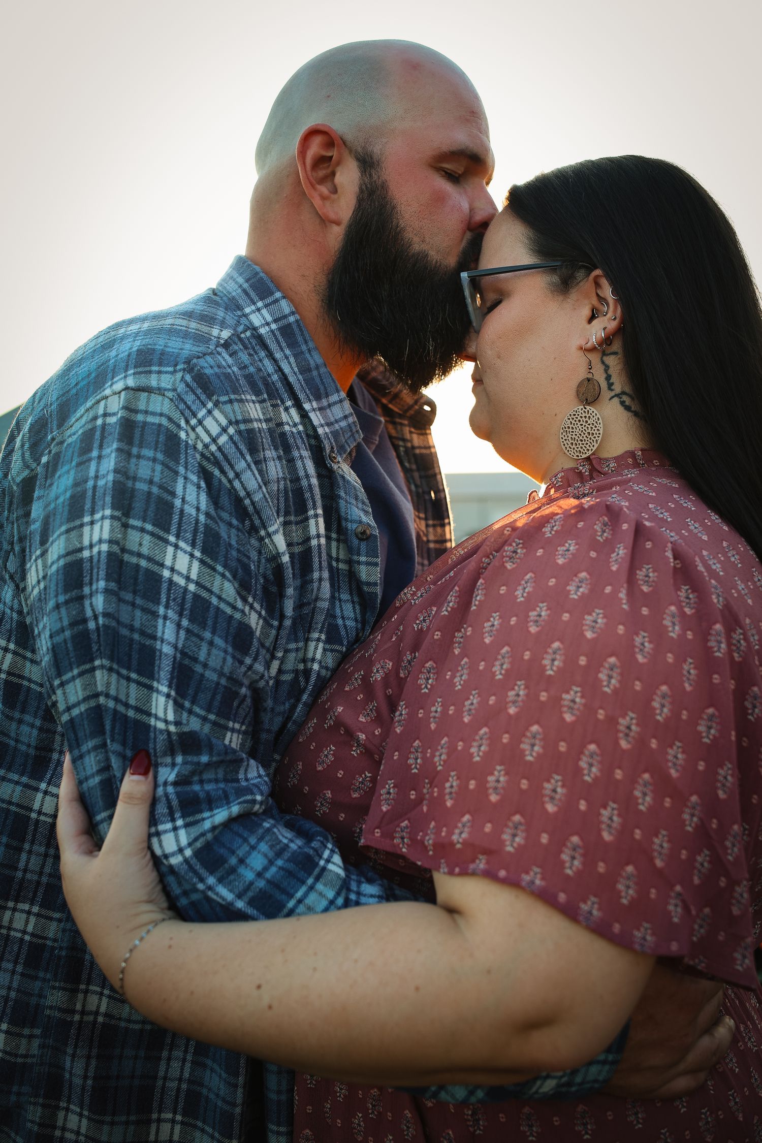 A couple shares an intimate moment in a series of four progressive photos showing them embracing and kissing.