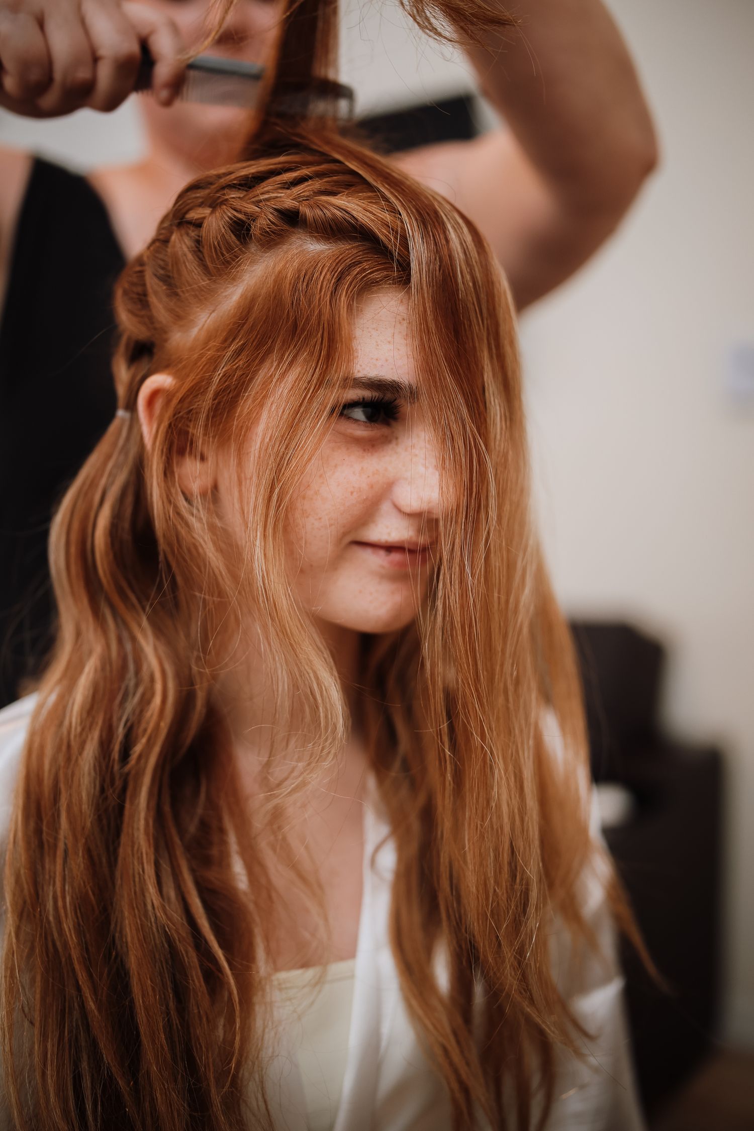 Series of photos showing long flowing red hair against a light background with soft natural lighting.