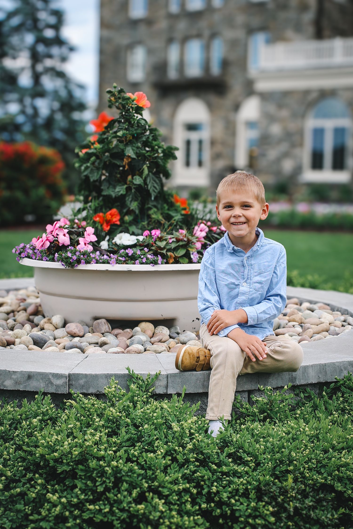 A series of photos showing a young person in a blue shirt sitting on a curved stone bench surrounded by flowers and greenery.