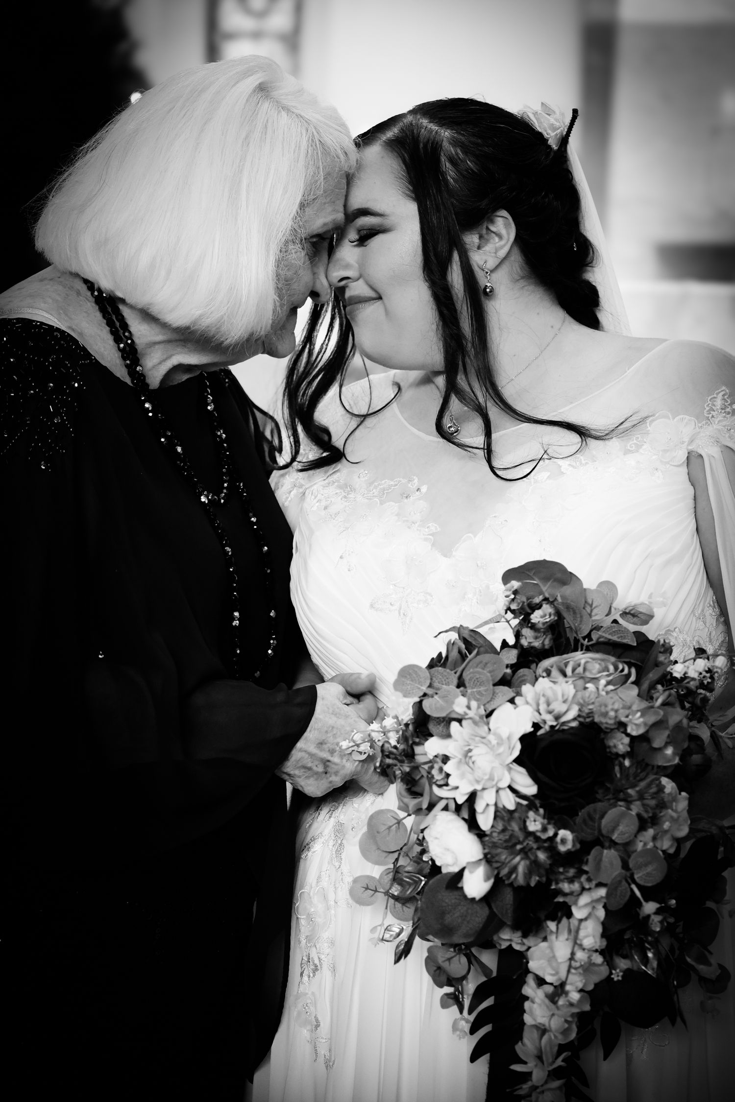 Black and white wedding photos showing romantic moments with bridal bouquets and white gowns.