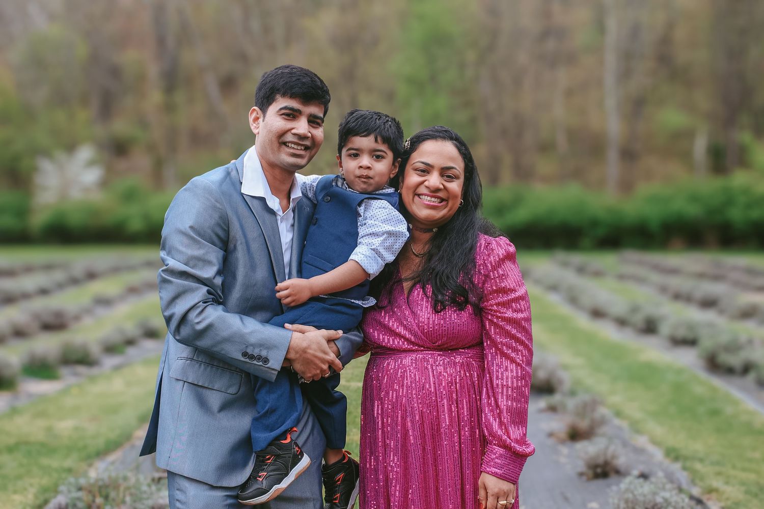 Family enjoying a candid moment together in a lavender field during a spring photo session.