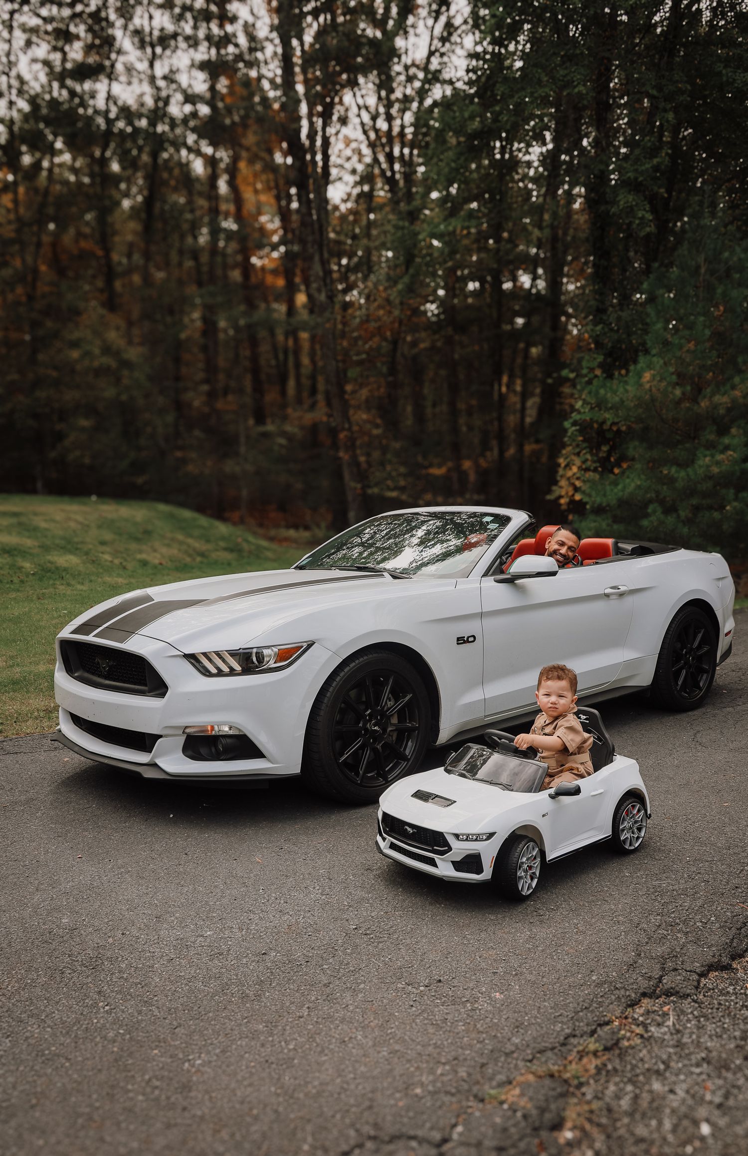 A series of photos showing a white Ford Mustang convertible next to a matching miniature toy car on a wooded road.
