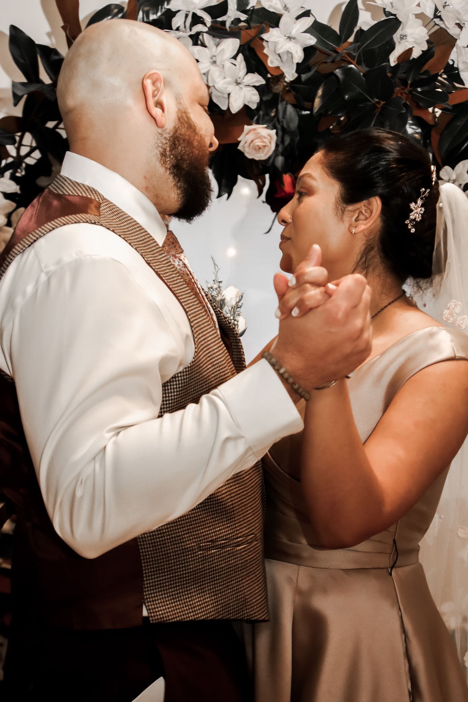 A romantic collage of wedding moments showing a couple sharing intimate kisses under floral decorations.