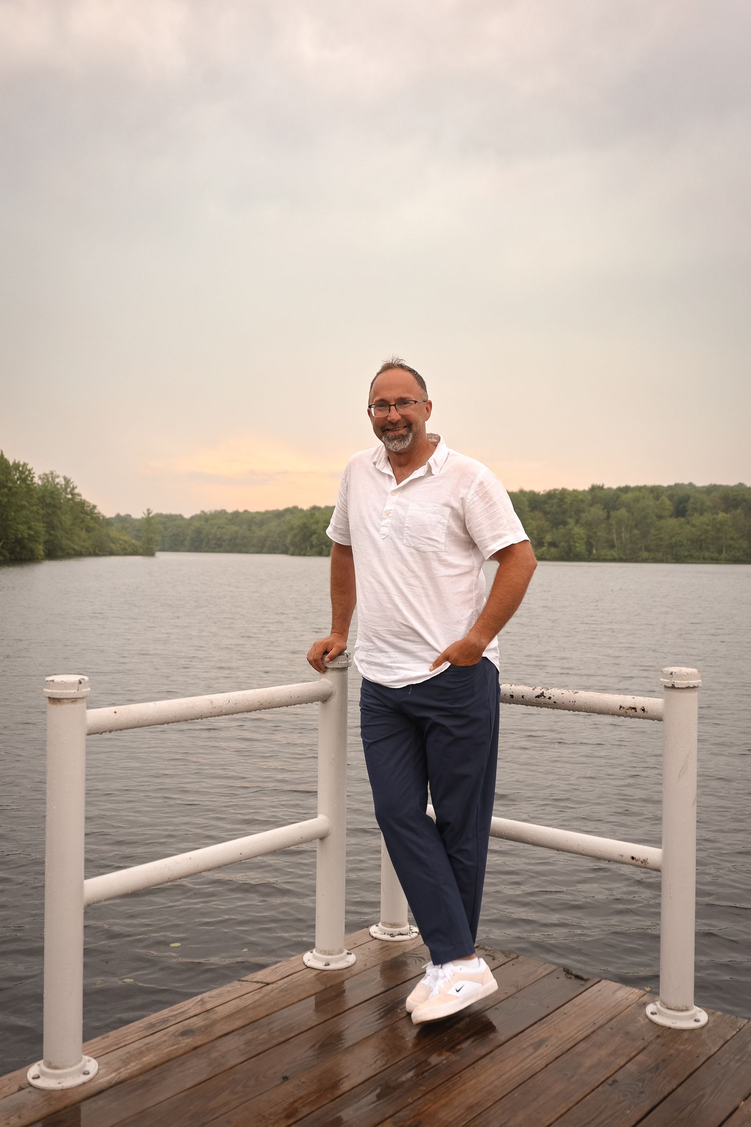 A sequence of photos showing a person in a white shirt and dark pants on a wooden dock by a lake.