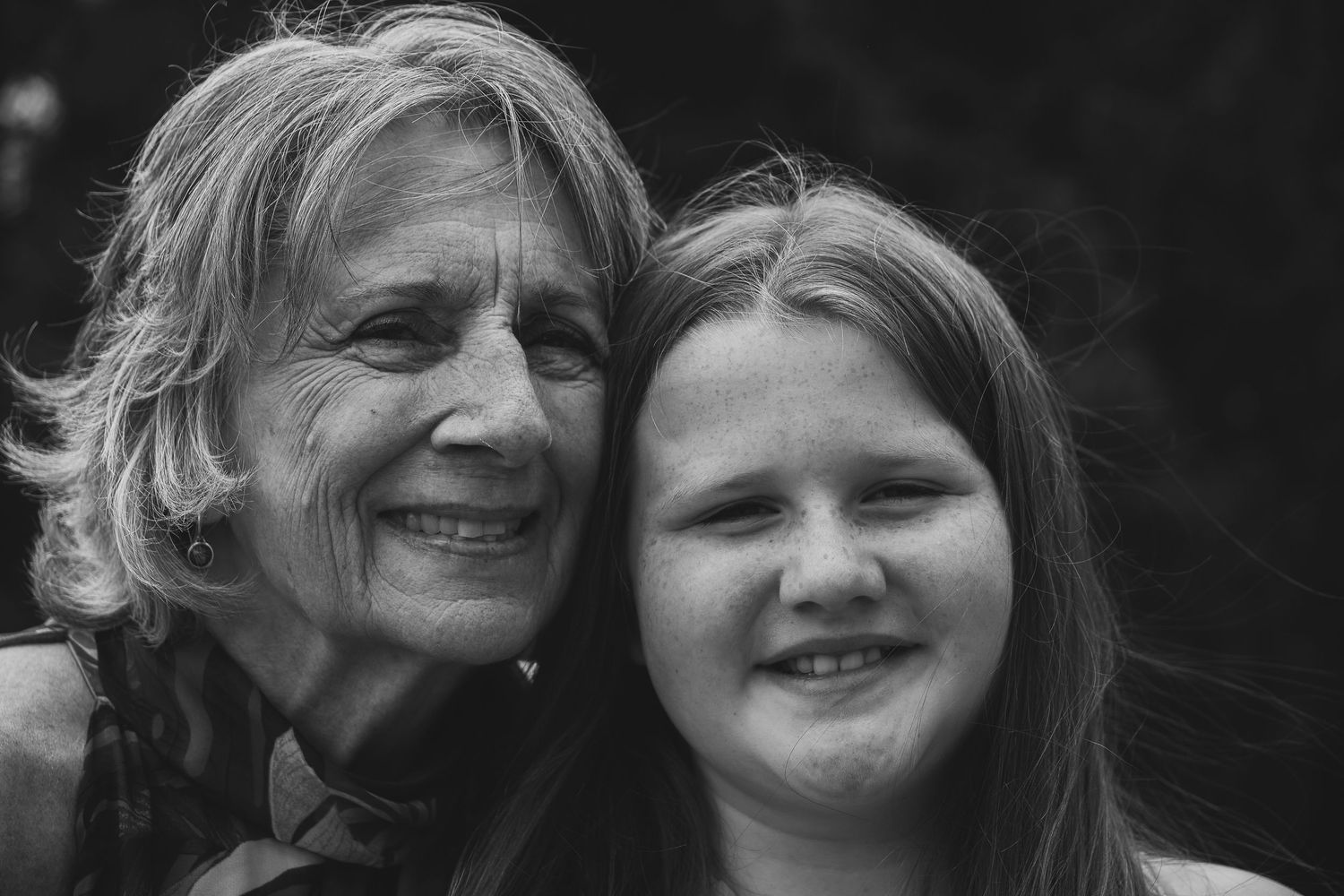 A series of black and white portrait photographs showing two people smiling and embracing together.