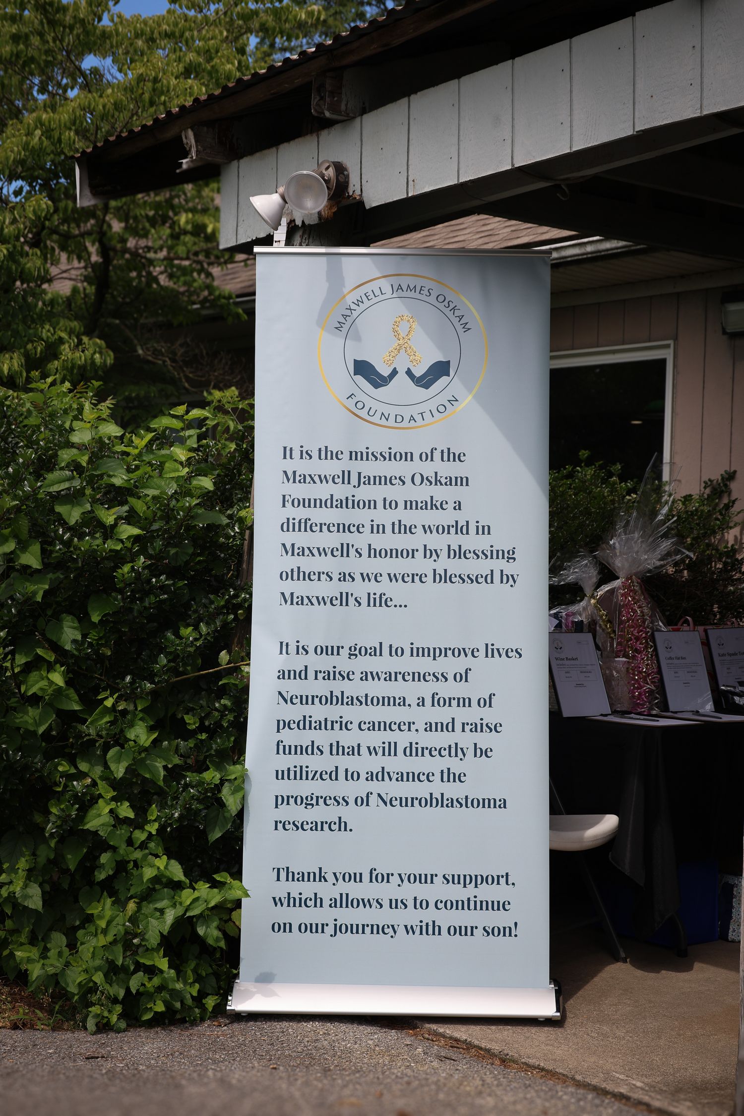 A series of outdoor signs with text about a foundation's mission and goals displayed against a white background.