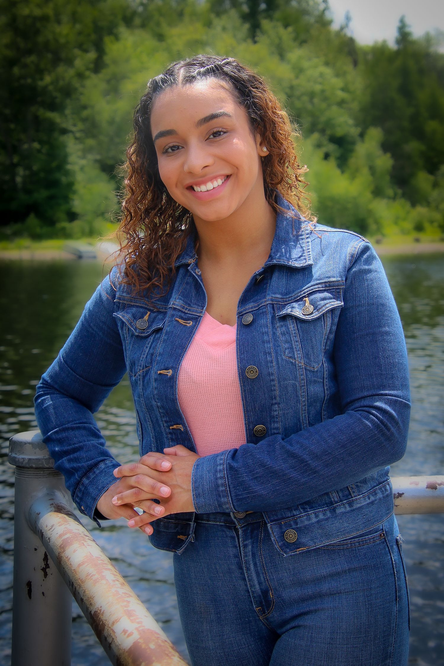 A series of outdoor portraits showing someone in a denim jacket and pink top posing near a lake on a sunny day.