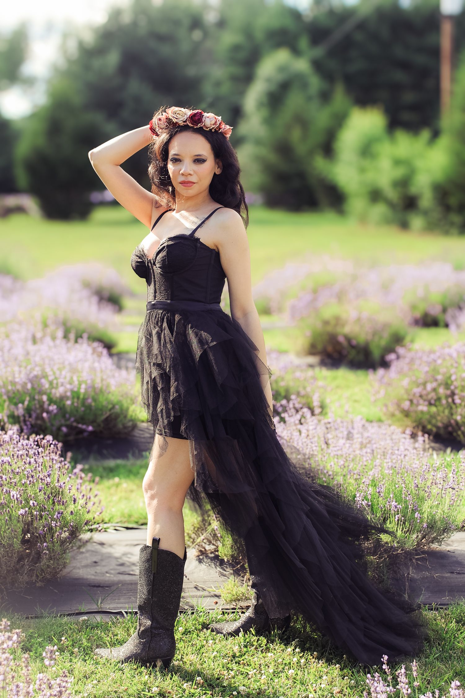 Ethereal fashion photo series in a blooming lavender field with flowing black tulle fabric creating dramatic movement.