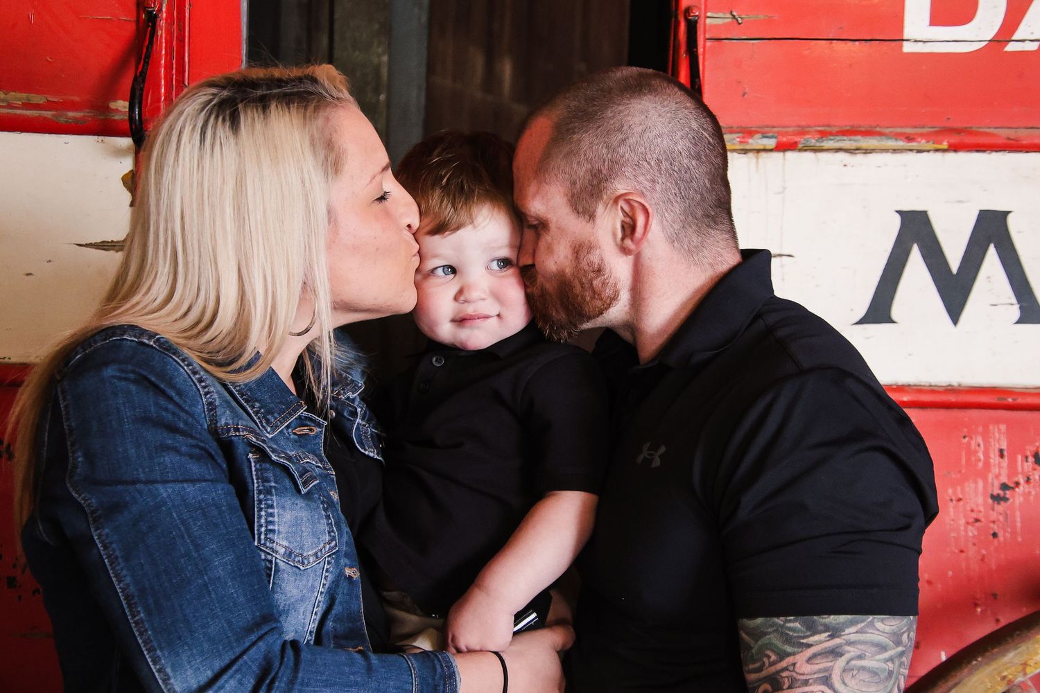 A series of romantic couple photos showing tender moments against a red barn wall background.