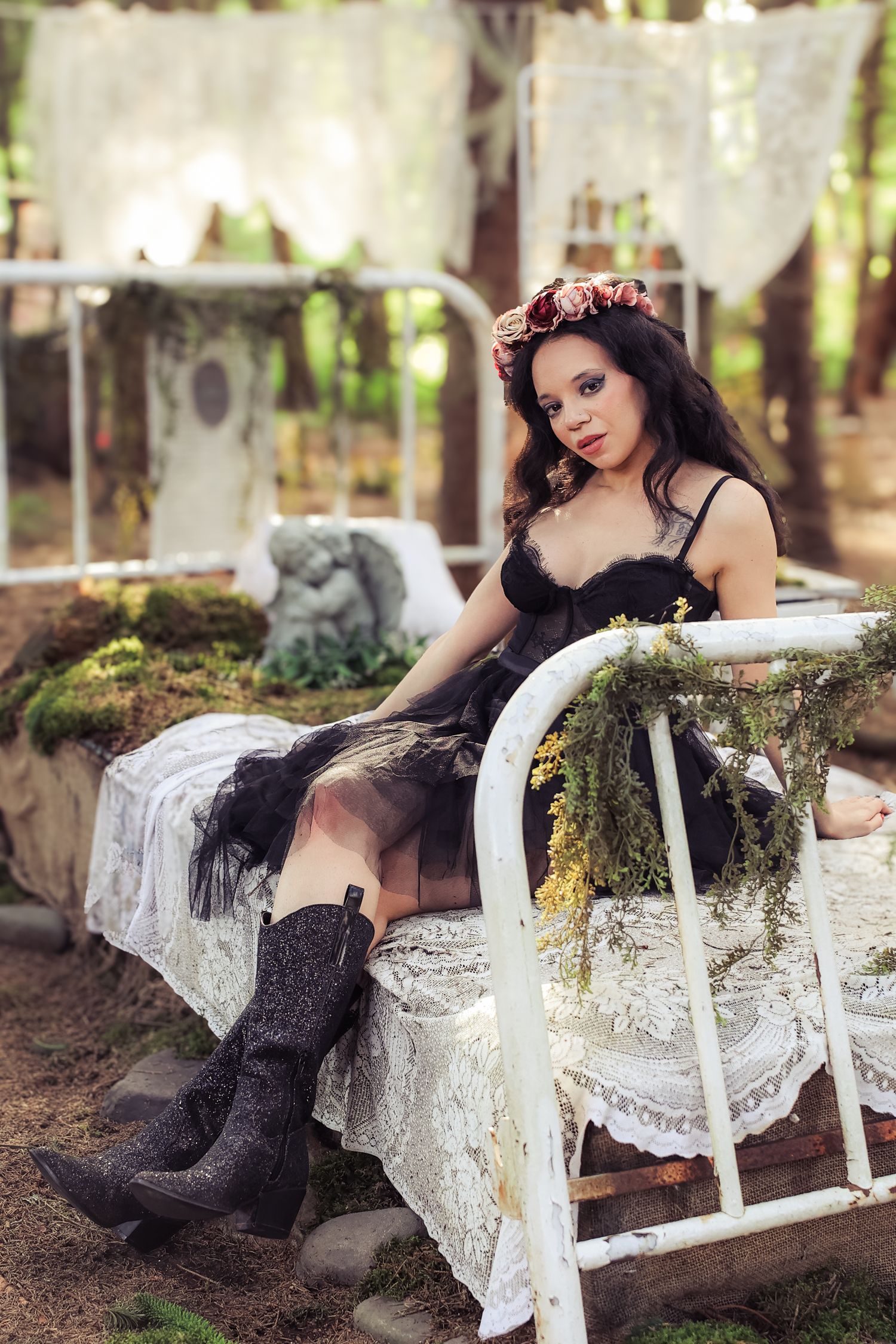 A dark-themed outdoor photo series featuring a vintage white lace-draped chaise lounge in a forest setting.