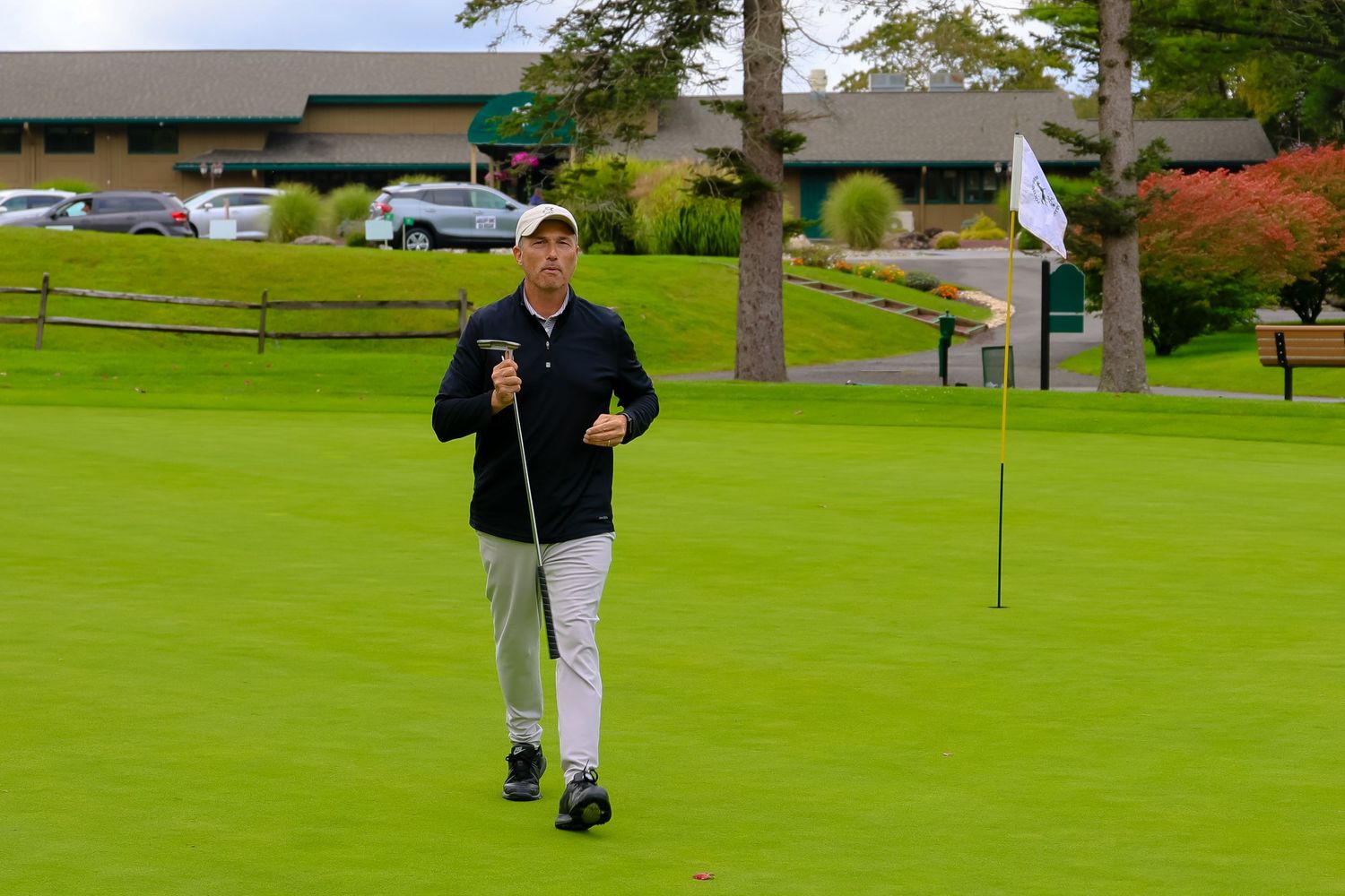 A scenic view of a well-maintained golf course with trees and fairways stretching into the distance.
