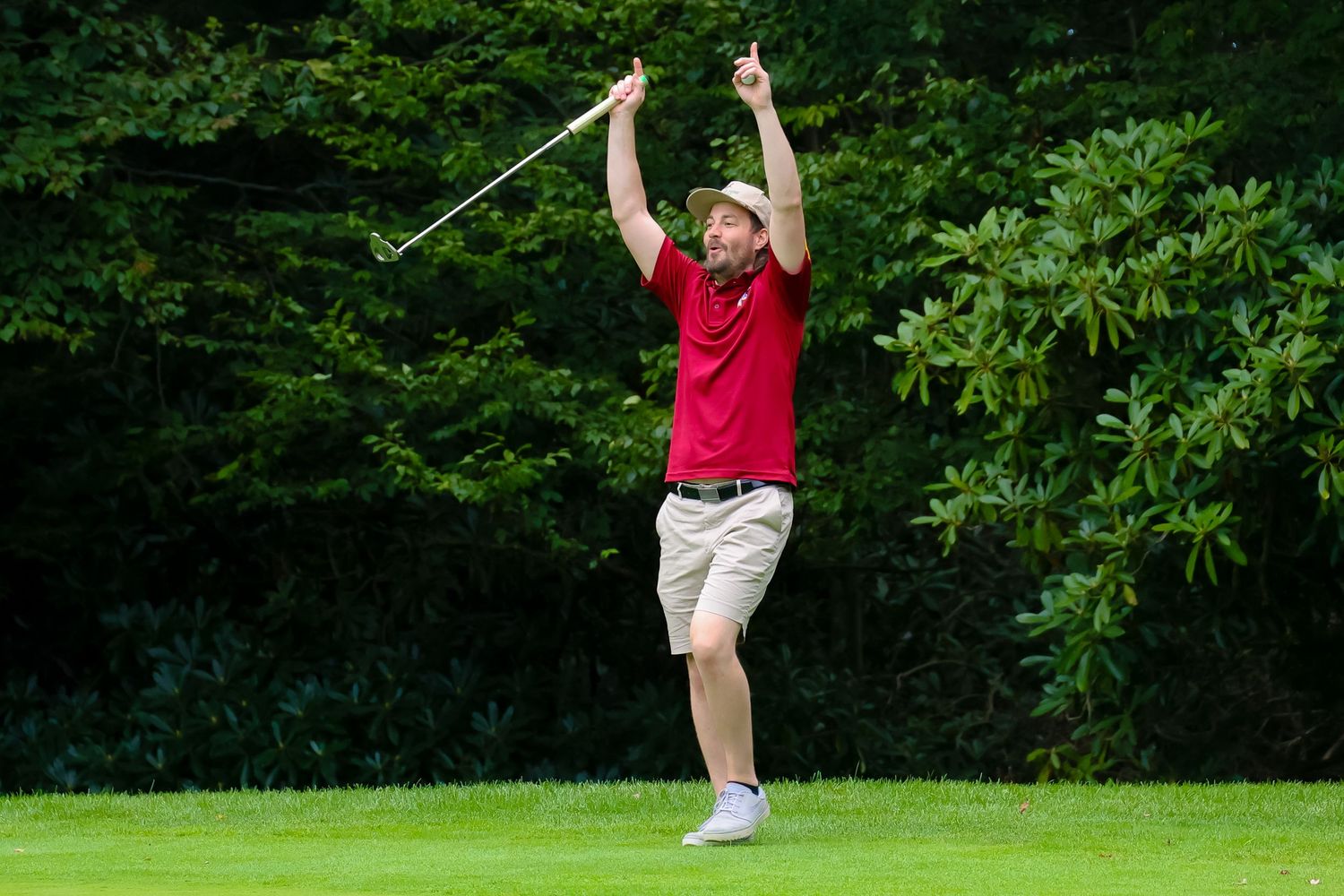 A golf swing sequence showing six frames of a player executing a full swing motion on a green course.
