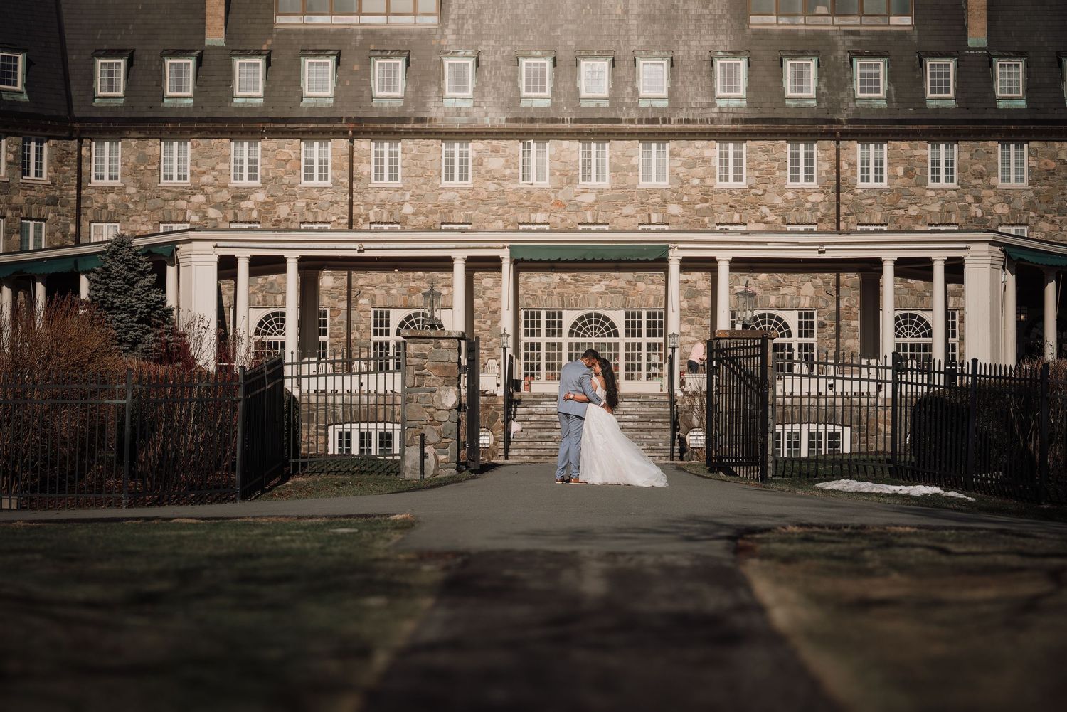 Historic brick buildings with arched windows and columns form a panoramic view of a classic architectural facade.