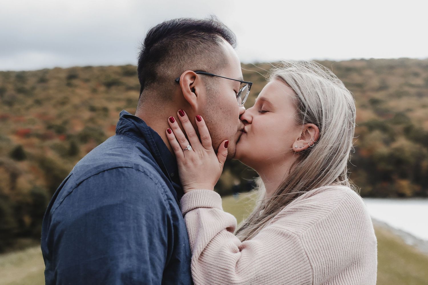 A romantic photo sequence shows a couple sharing tender kisses against an autumn lakeside backdrop.