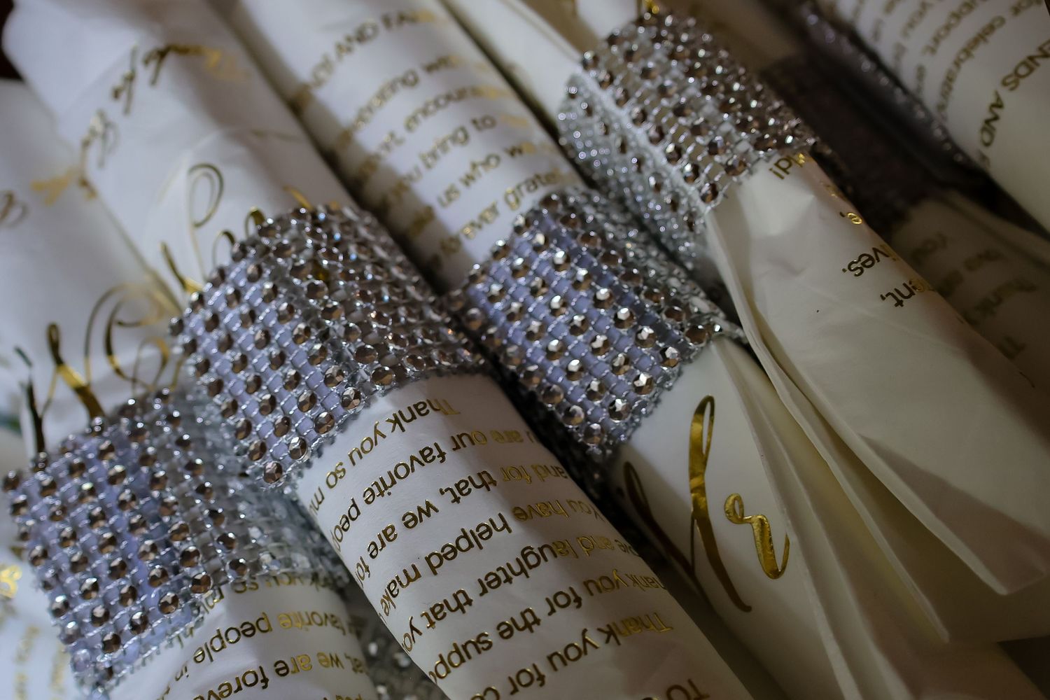 Close-up view of handwritten text on paper with decorative rhinestone embellishments along the edges.