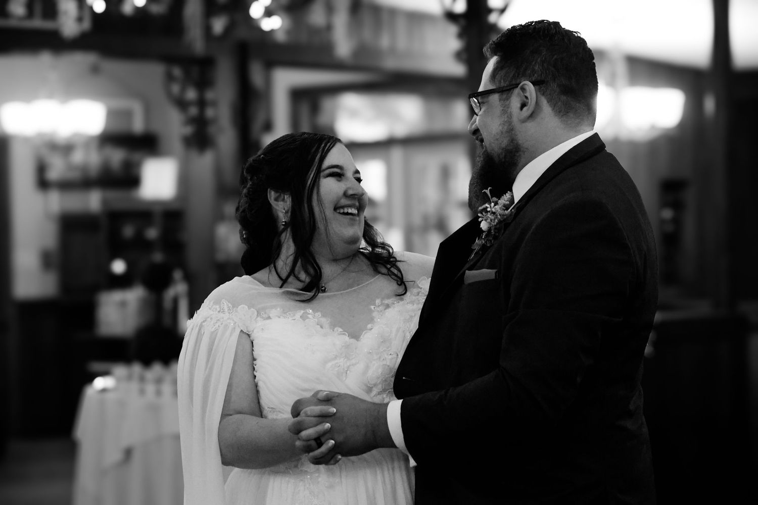A black and white wedding photo collage showing intimate moments between a couple during their celebration.