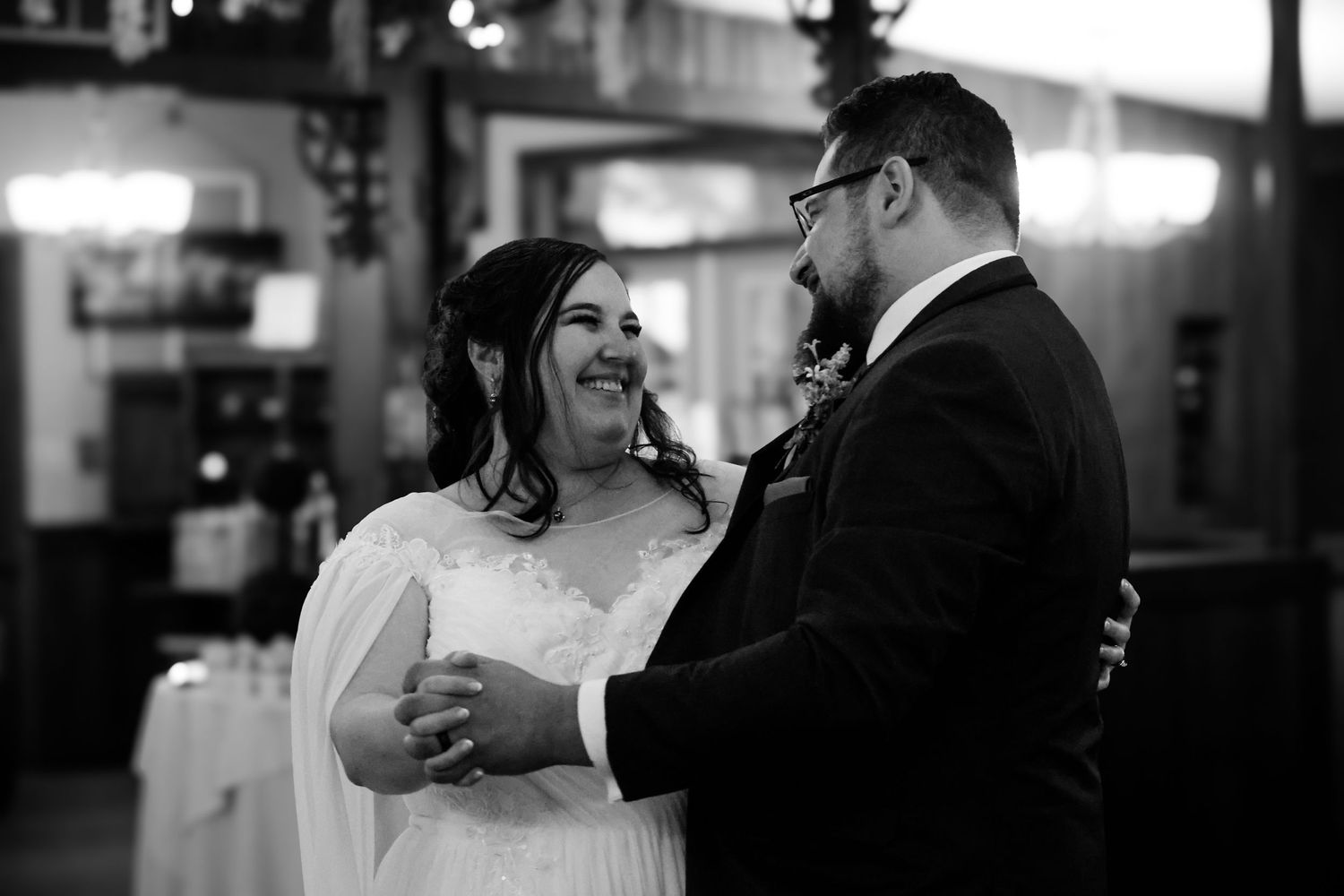 A black and white photo collage showing intimate wedding dance moments between couples at a reception.