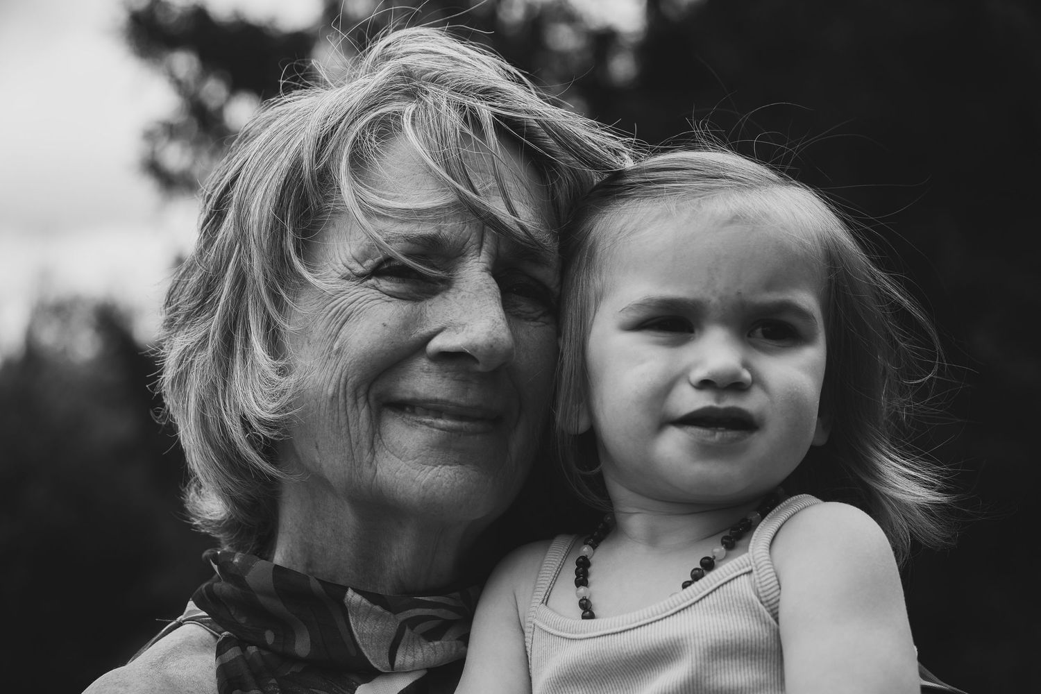 A series of black and white photos showing a child with windswept hair and expressive emotions.