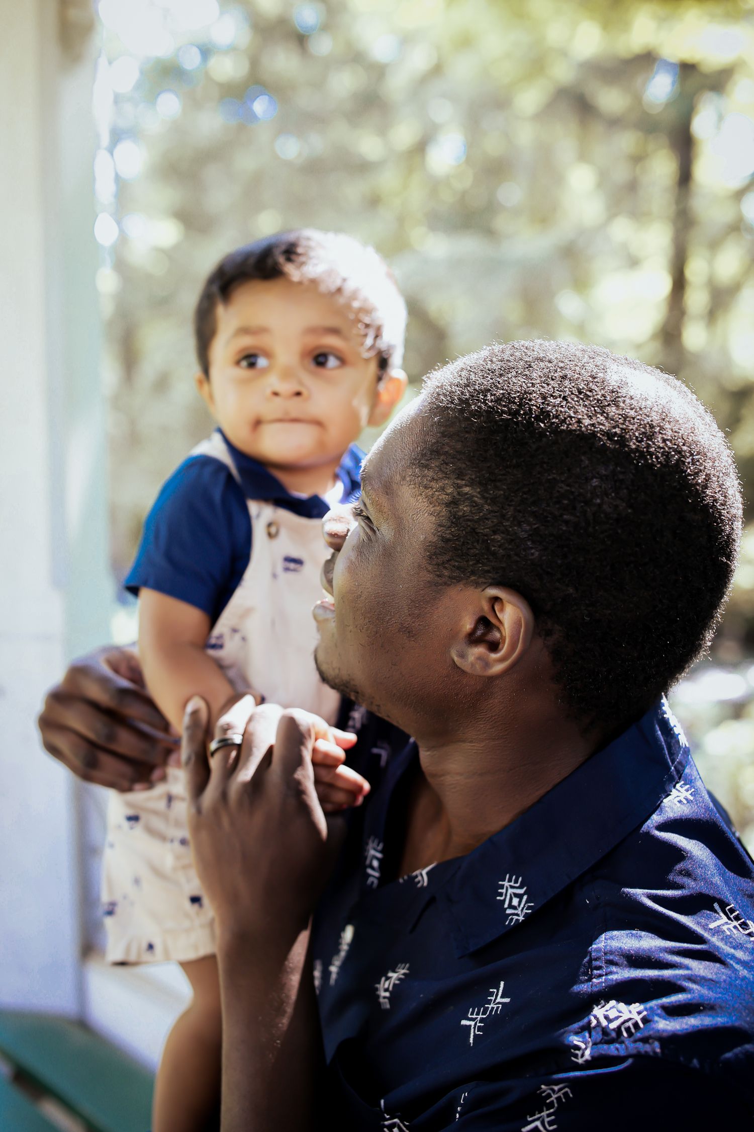 A heartwarming series of photos showing tender moments between a parent and baby in a sunny outdoor setting.