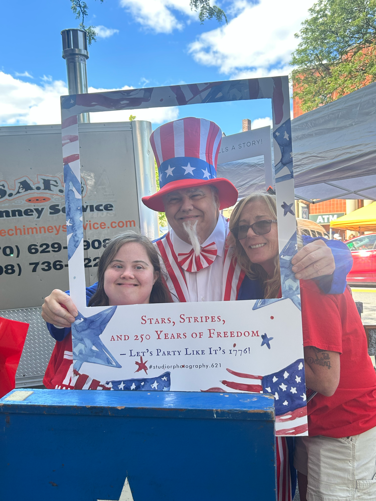 Patriotic themed voter registration booth at an outdoor event with American flags and red white and blue decorations.