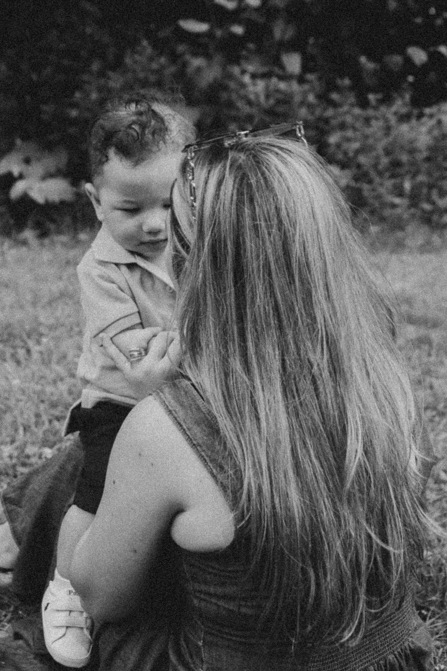 A black and white photo series showing an intimate moment between two people in a natural outdoor setting.
