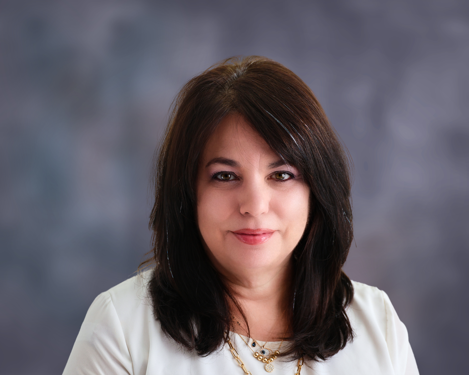 A series of headshots showing a person with dark hair wearing a white top against a gray background.