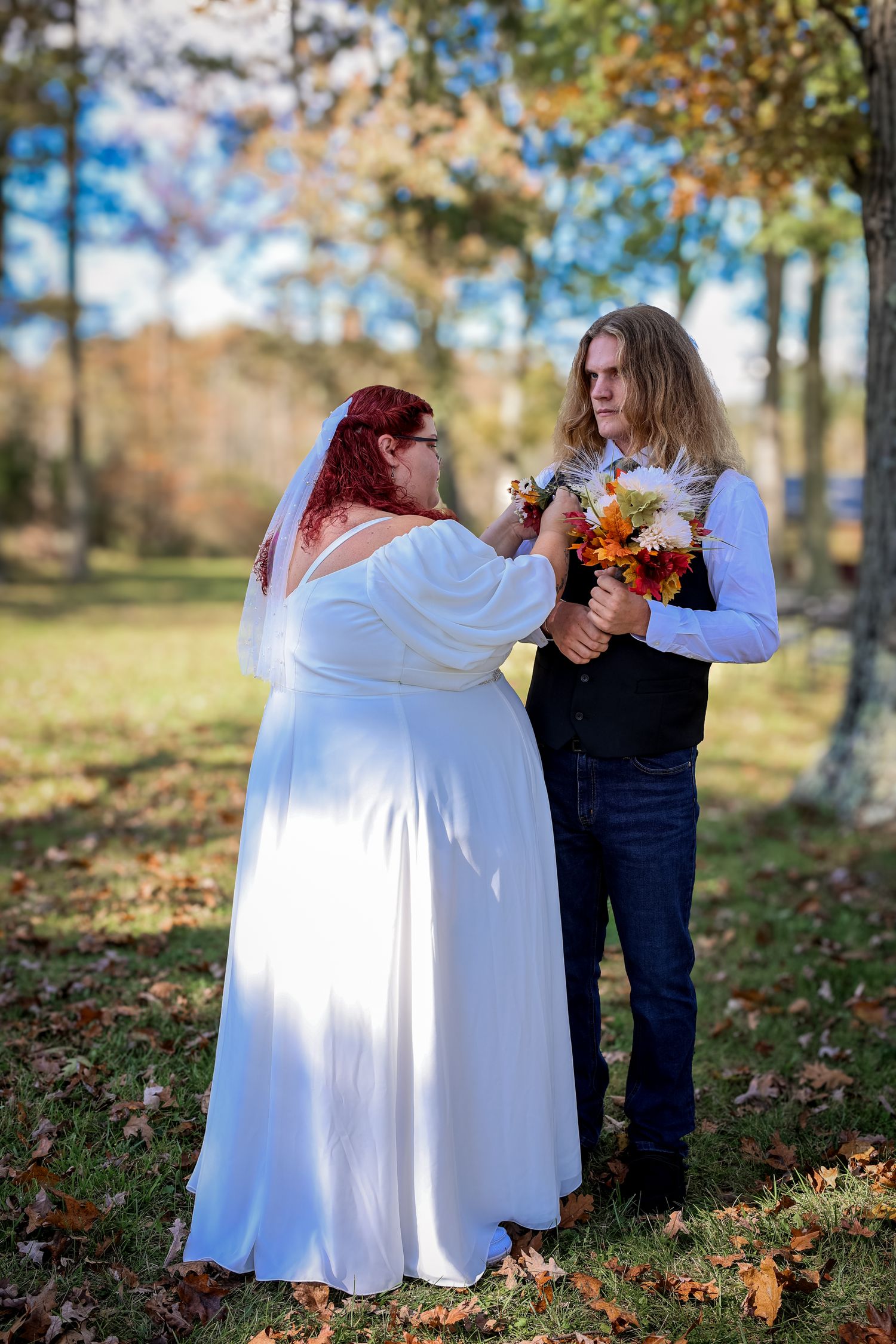 A series of four romantic outdoor autumn photos showing a couple embracing among fallen leaves and trees.