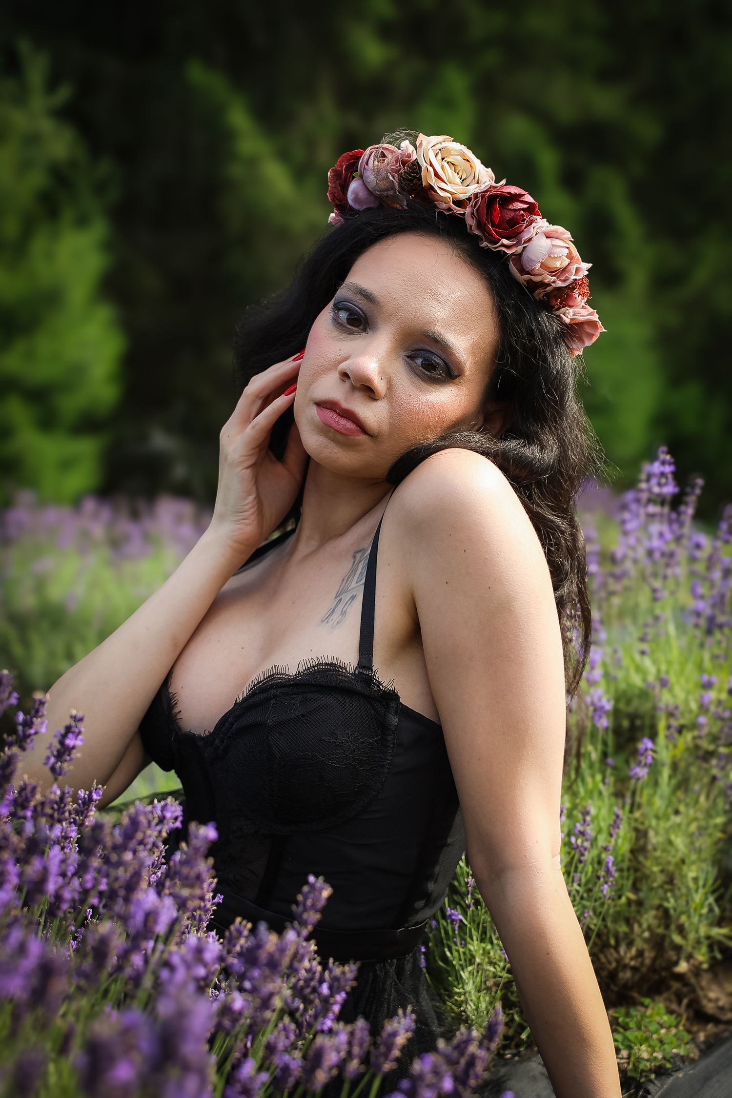 A romantic portrait in a lavender field features a black dress and floral crown against lush purple blooms and greenery.