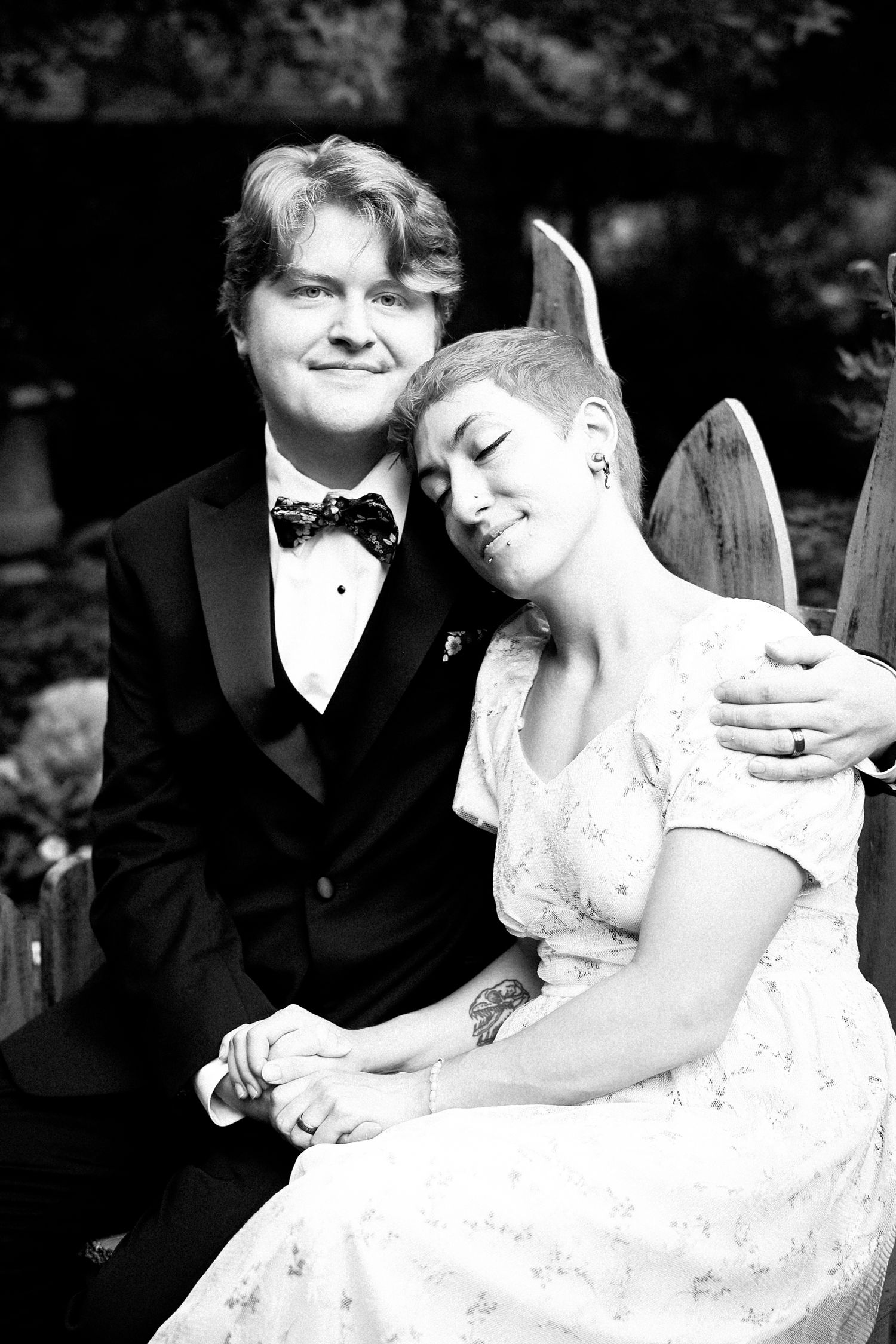 A romantic black and white wedding photo series showing tender moments between a bride in white lace and groom in tuxedo.