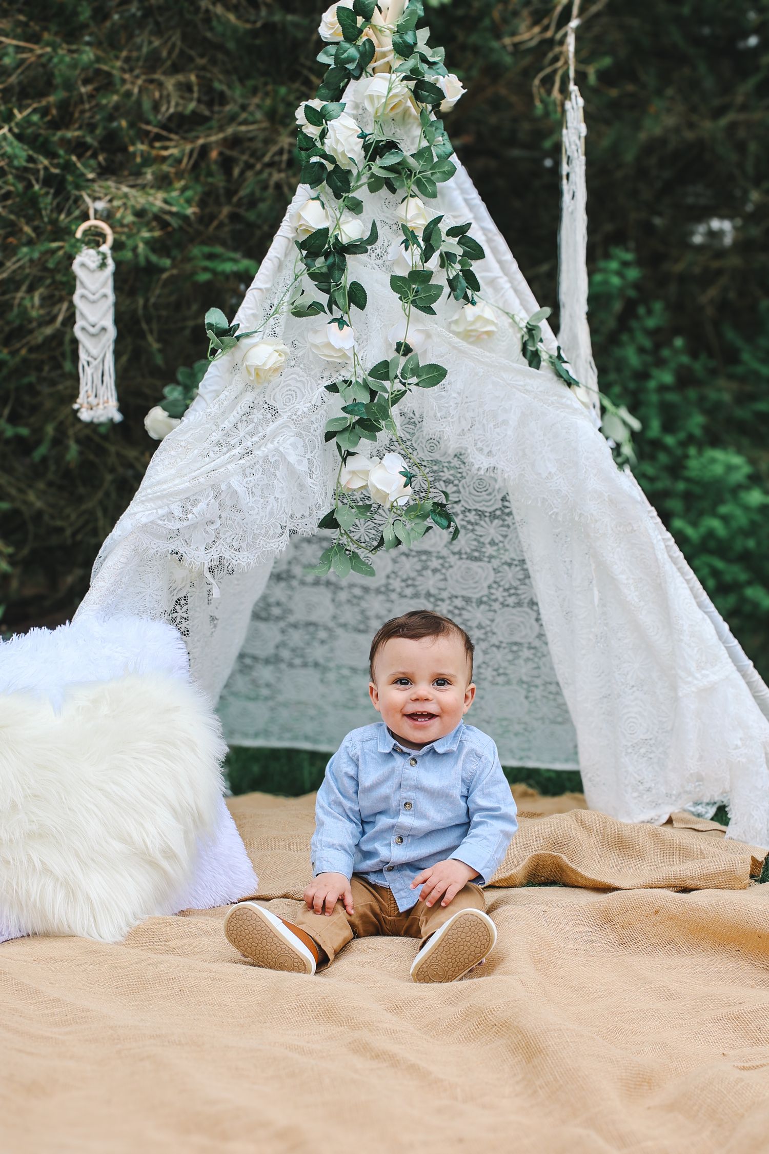 A series of sweet milestone photos showing a baby sitting against a white lace teepee tent with greenery decorations.