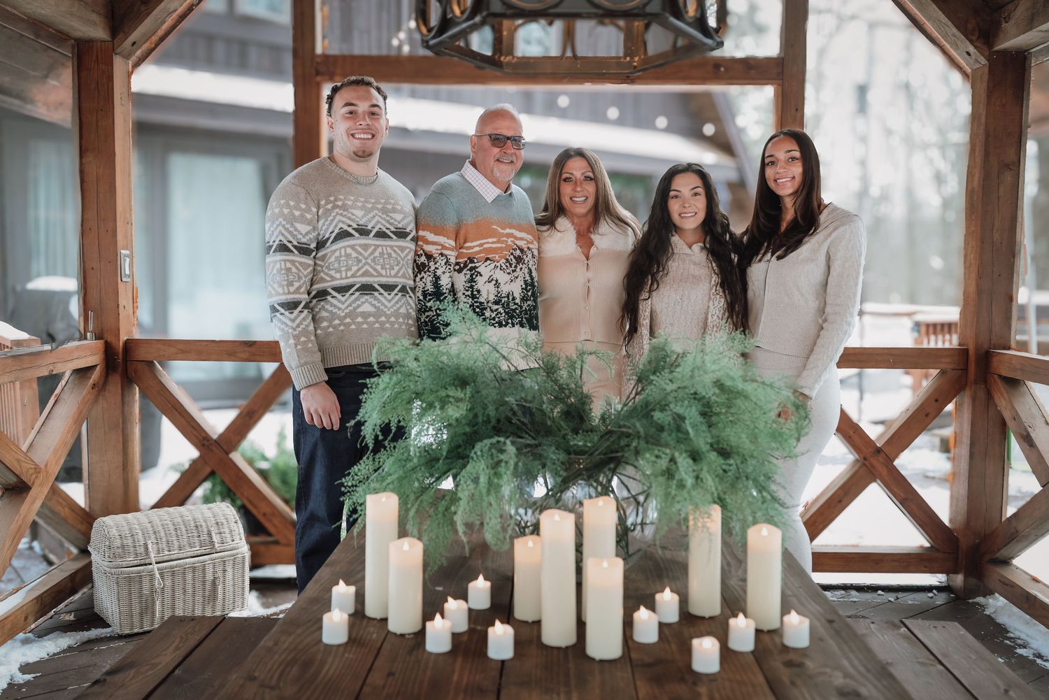 A rustic wooden gazebo decorated with white candles and greenery for an elegant outdoor wedding celebration.