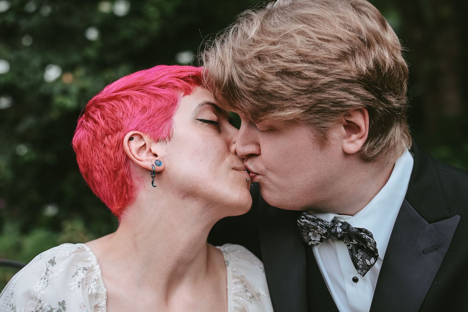 A series of romantic wedding photos showing a couple kissing in a garden setting.