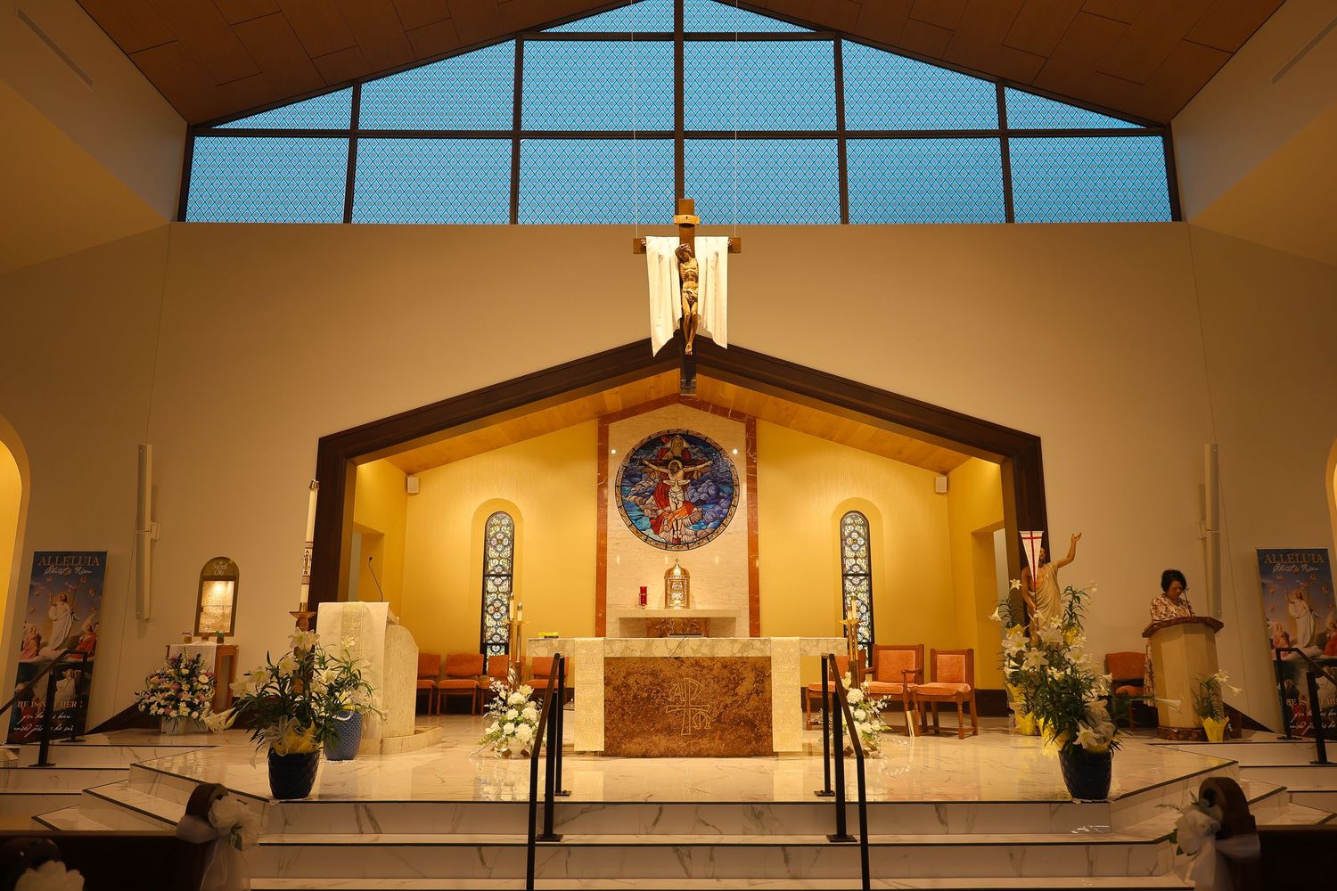 Interior panoramic view of a modern church sanctuary with clerestory windows and simple altar design.