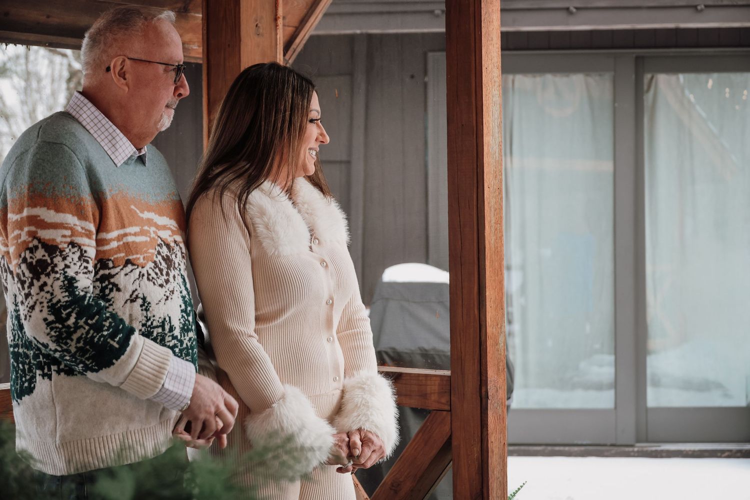 A bride and groom share an intimate moment during their wedding ceremony in a rustic wooden setting.
