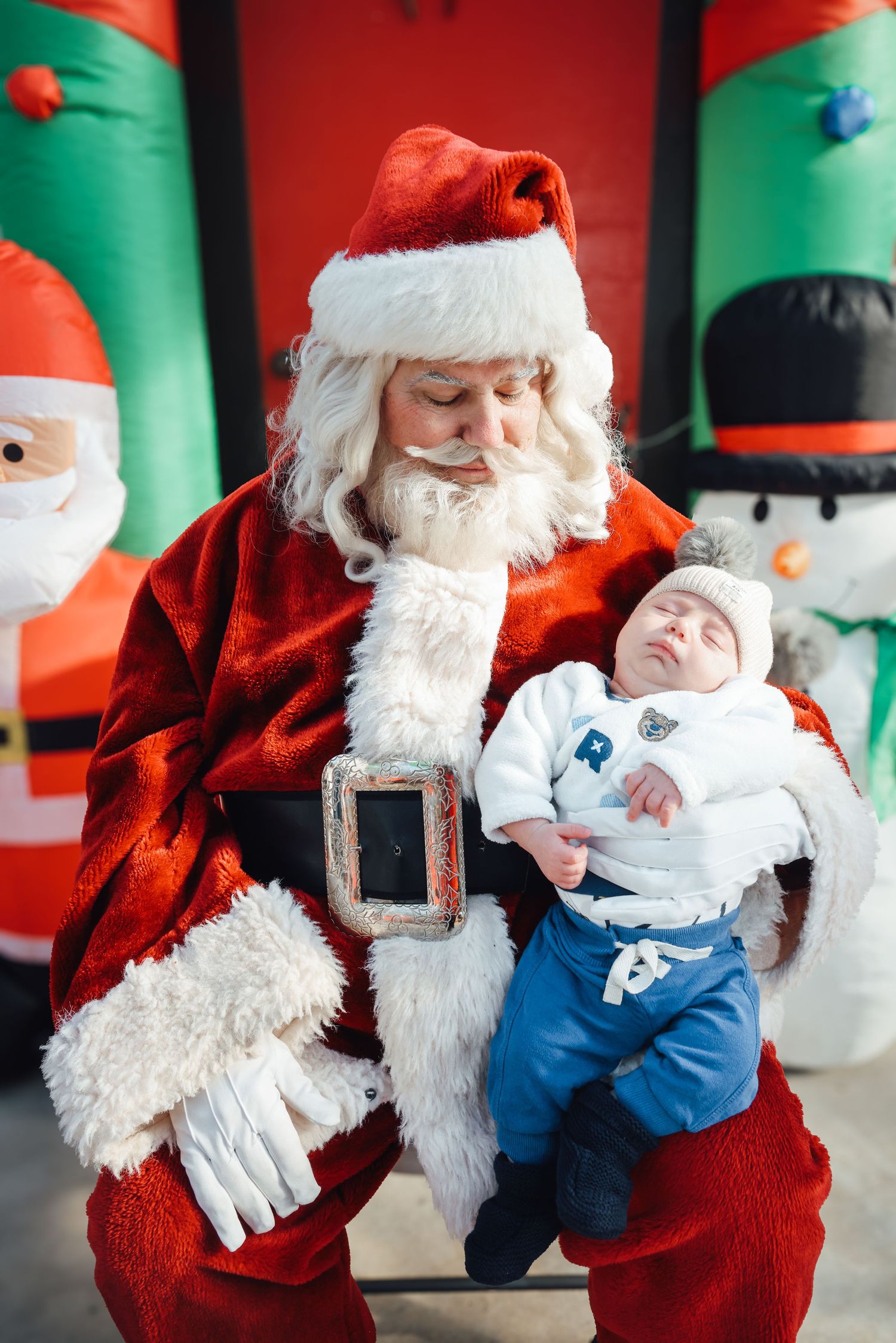 A series of photos showing a baby's funny reactions while sitting with Santa Claus in a holiday photo session.