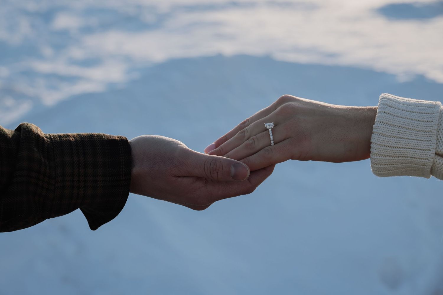 A sequence of hands passing a white envelope in a relay style against a blue background.
