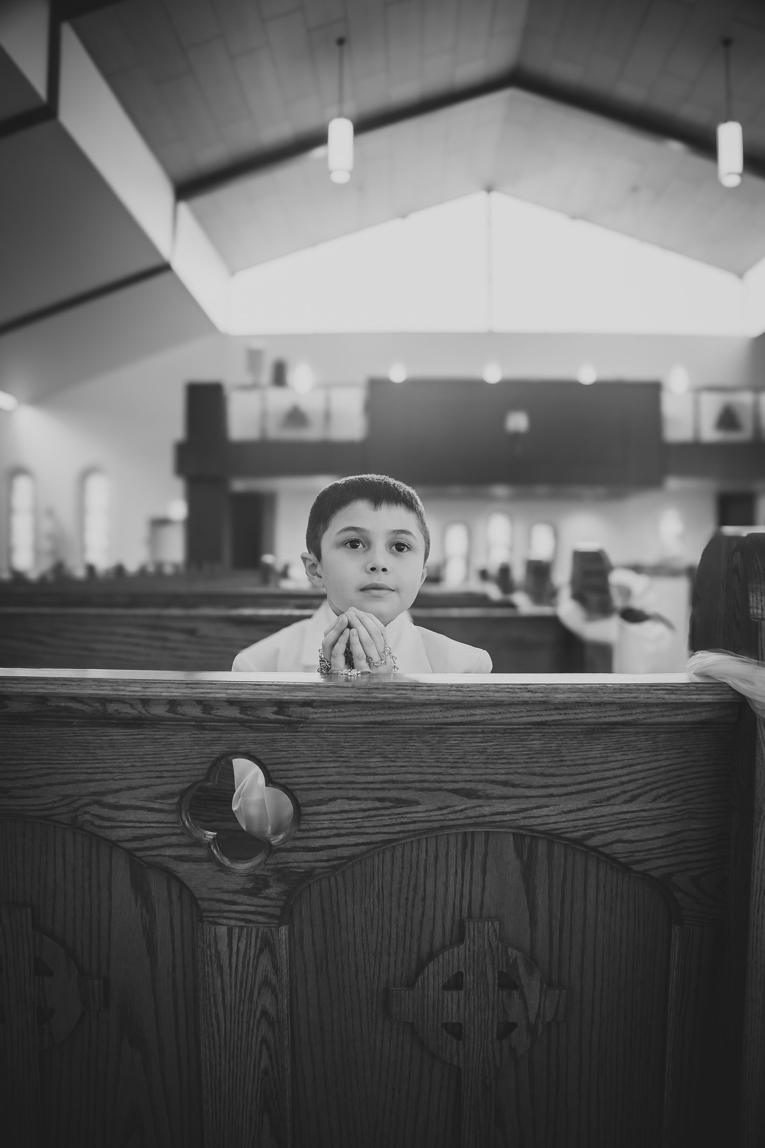 A black and white photo series showing someone peeking over a wooden church pew from different angles.