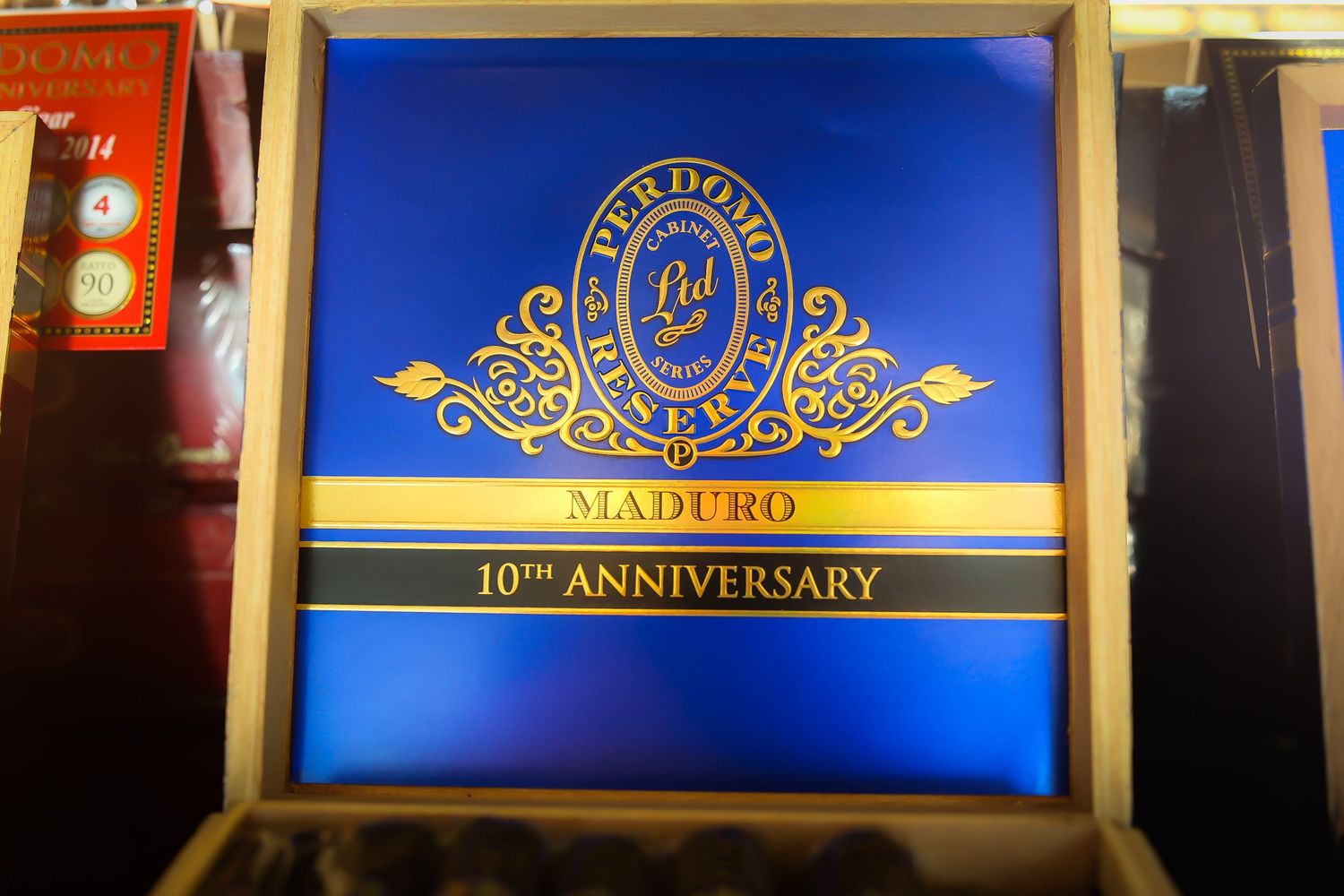 A series of gold-framed blue screens displaying ornate anniversary celebration graphics and logos.